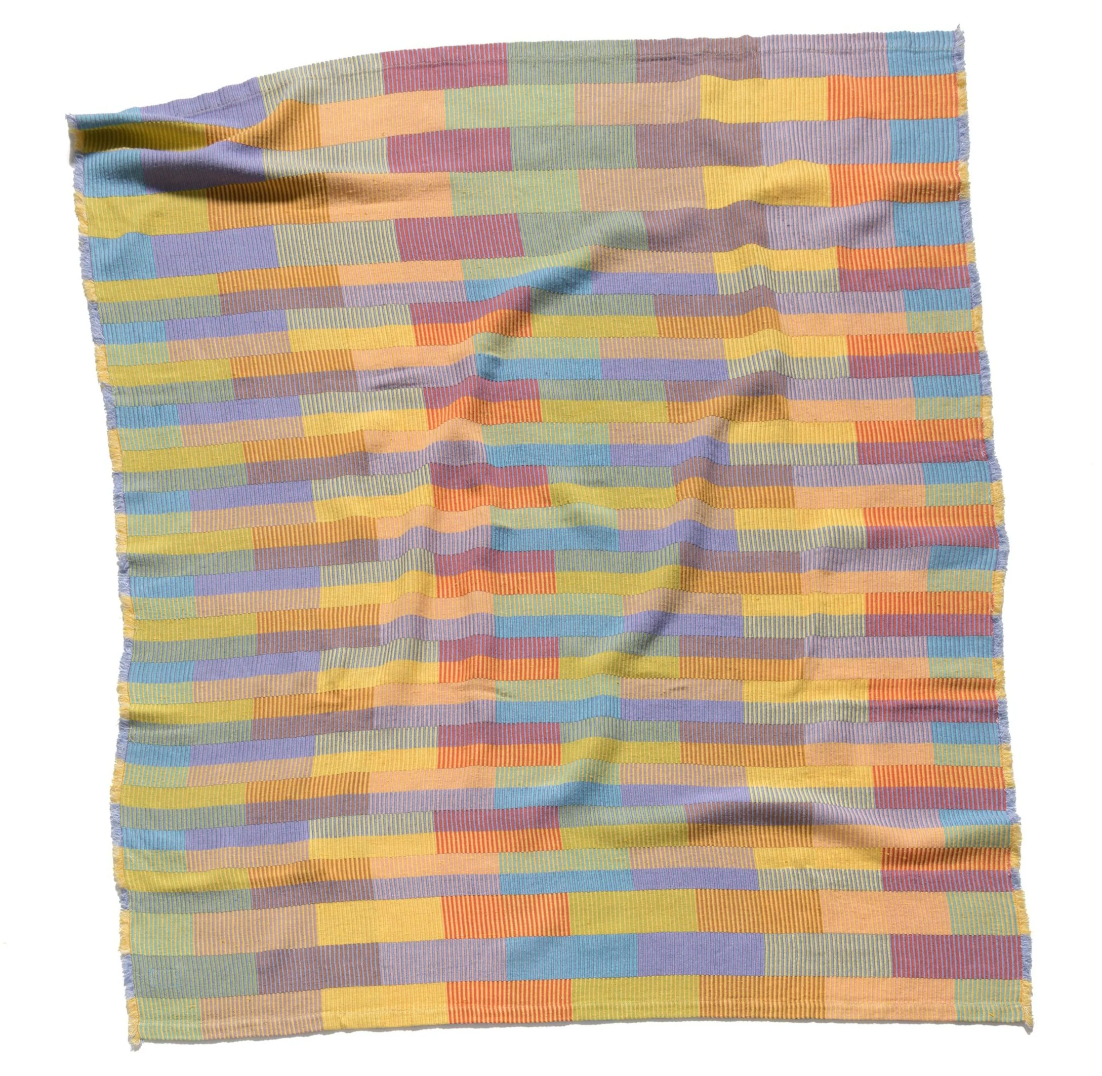 Multicolored blanket laying on a white background