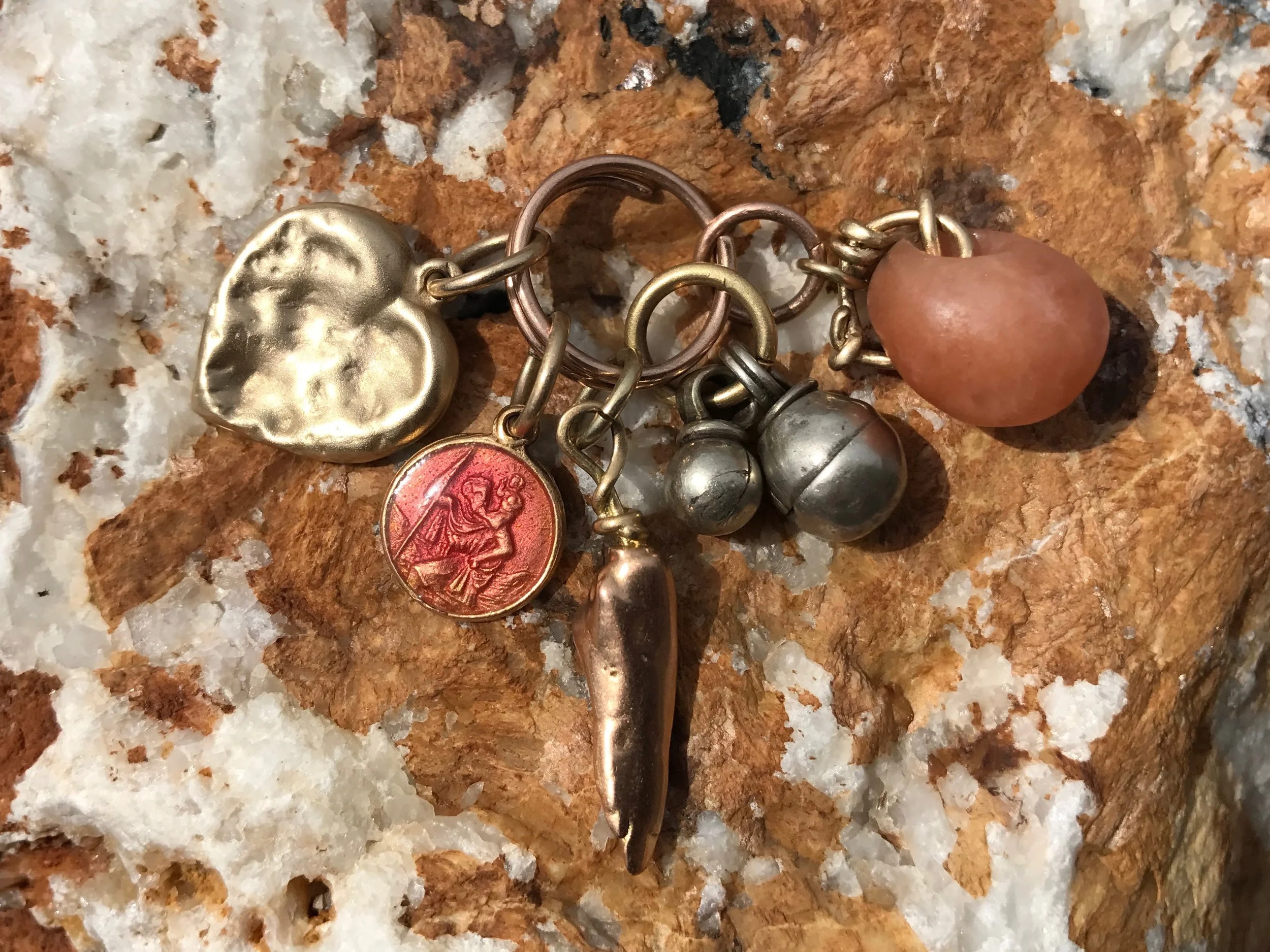 YELLOW GOLD CHEWED HEART, PINK ENAMEL ST. CHRISTOPHER, MISSISSIPPI PEARL CAST, BEDOUIN BELLS & CARNELIAN BEAD PENDANT