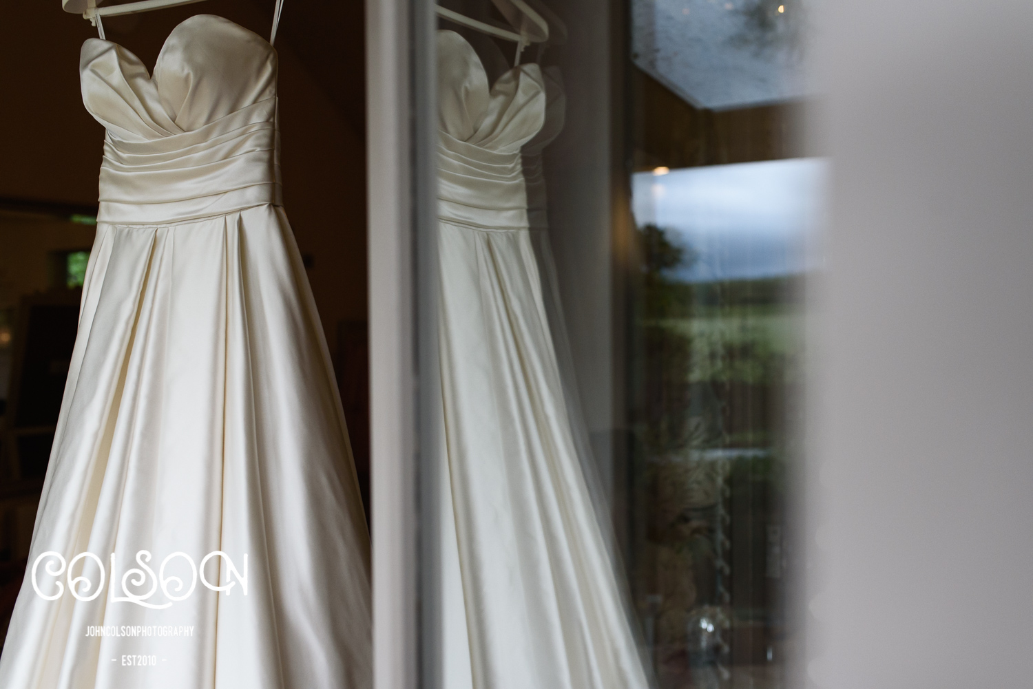 Rachels beautiful Wedding Dress hanging in the door way of the 'Hen House' at Lemore Manor.