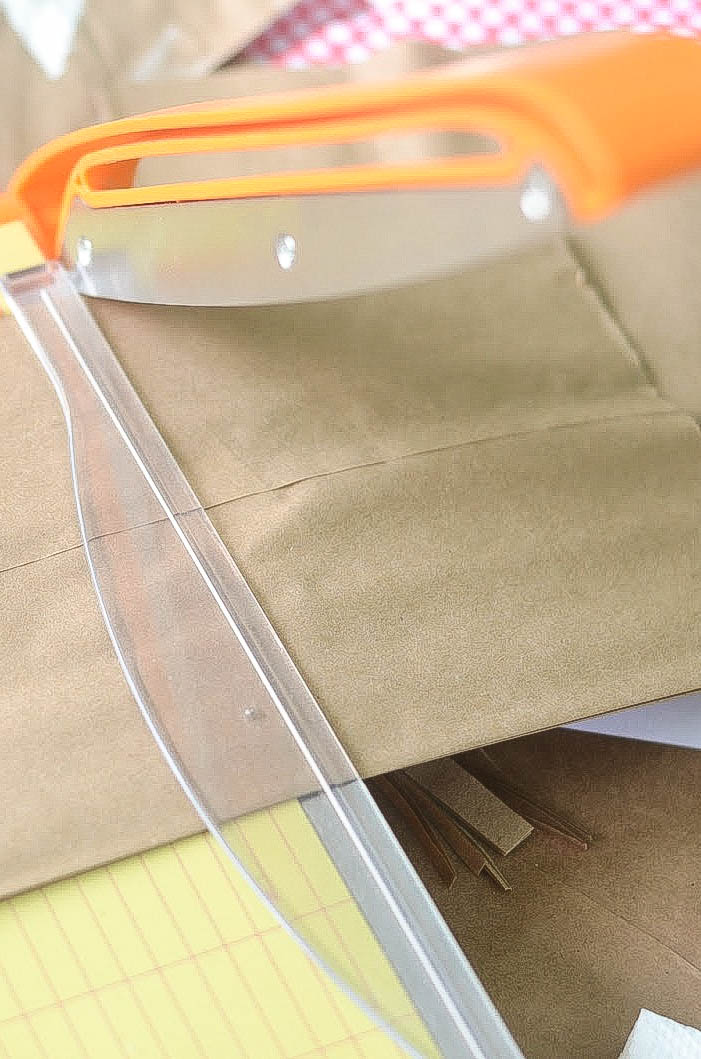 Cut off the top third of each lunch bag.