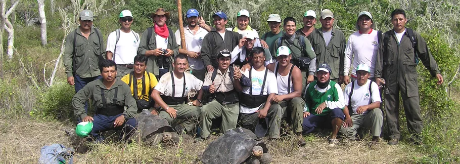 Galapagos National Park Guards proudly pose on Pinta Island, after having carried 39 Giant Tortoises into the highlands. Photo by Joe Flanagan