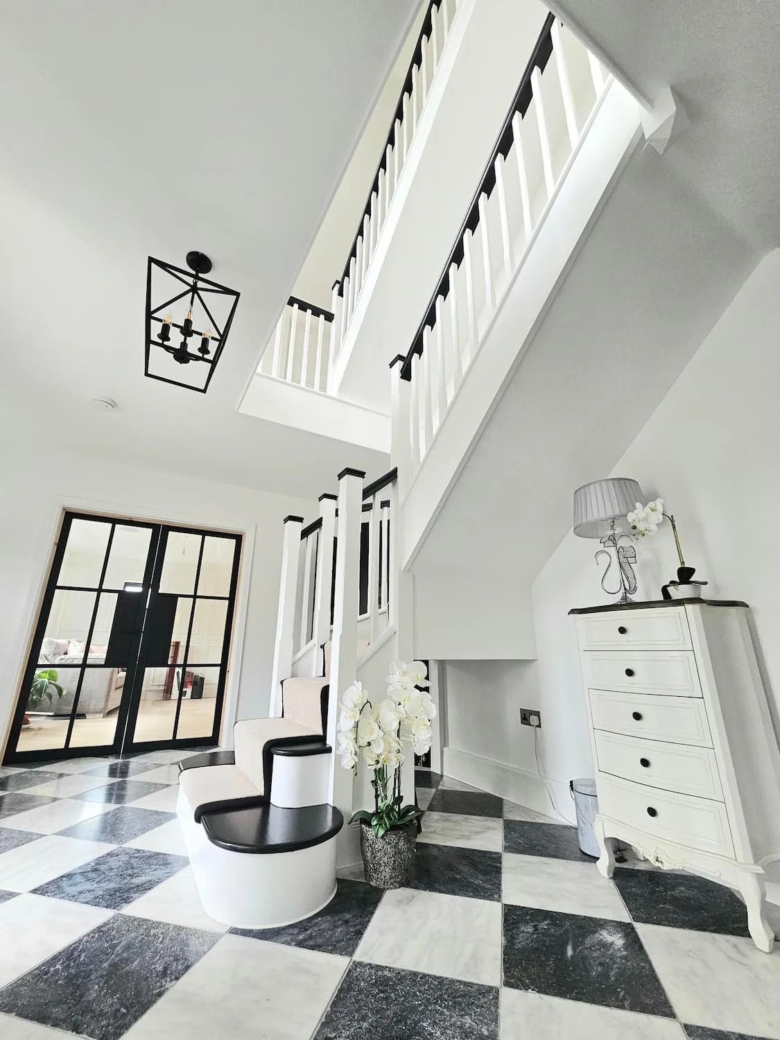 Luxury decorator skylark meadows, paintology. Gorgeous hallway with black and white staircase.