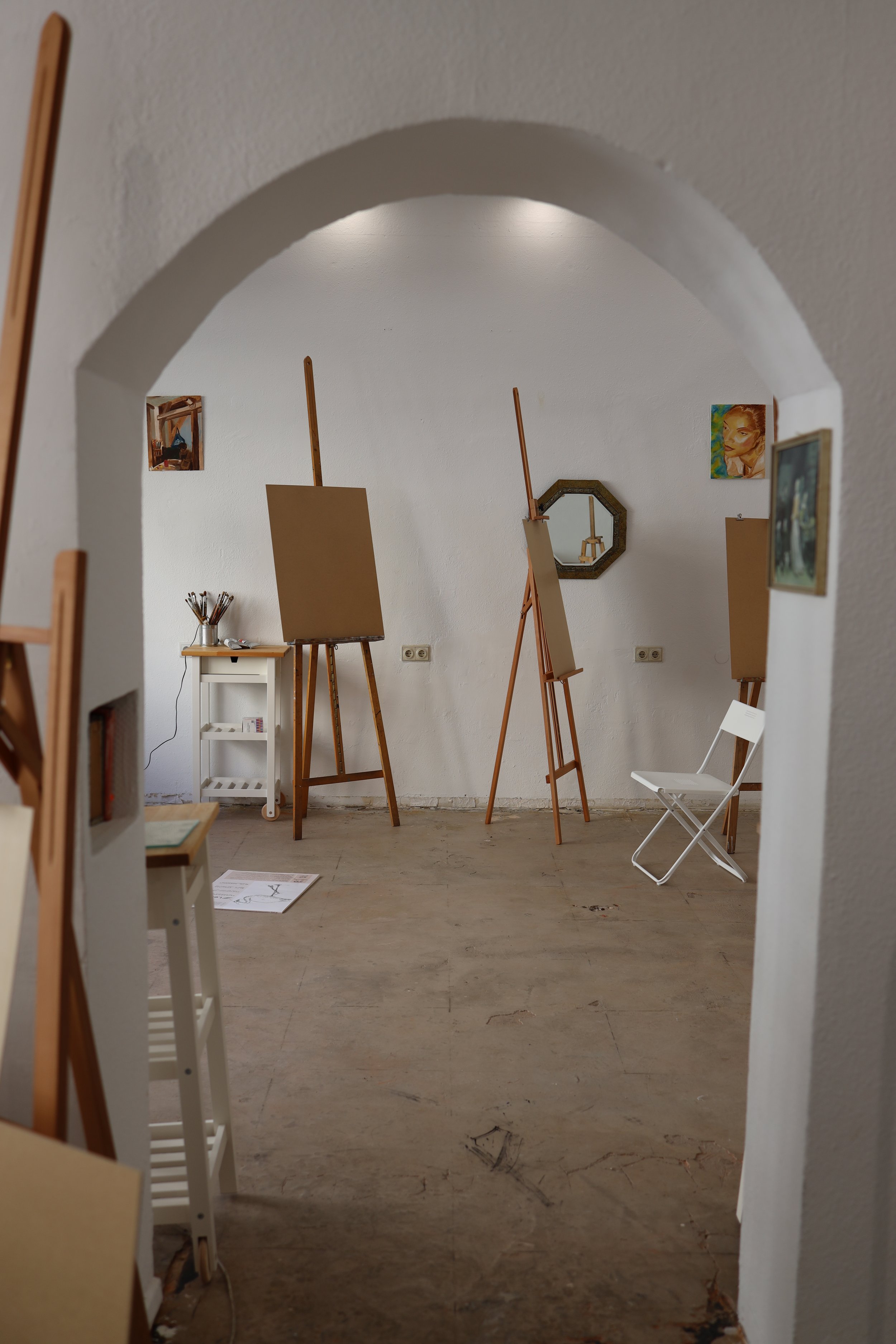 View through the doorway into the Charlottenburg painting studio, with easels and worktables.