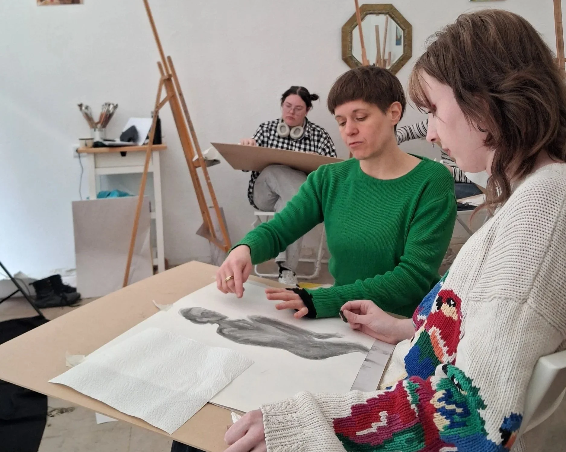 Emma guiding a student in a drawing class