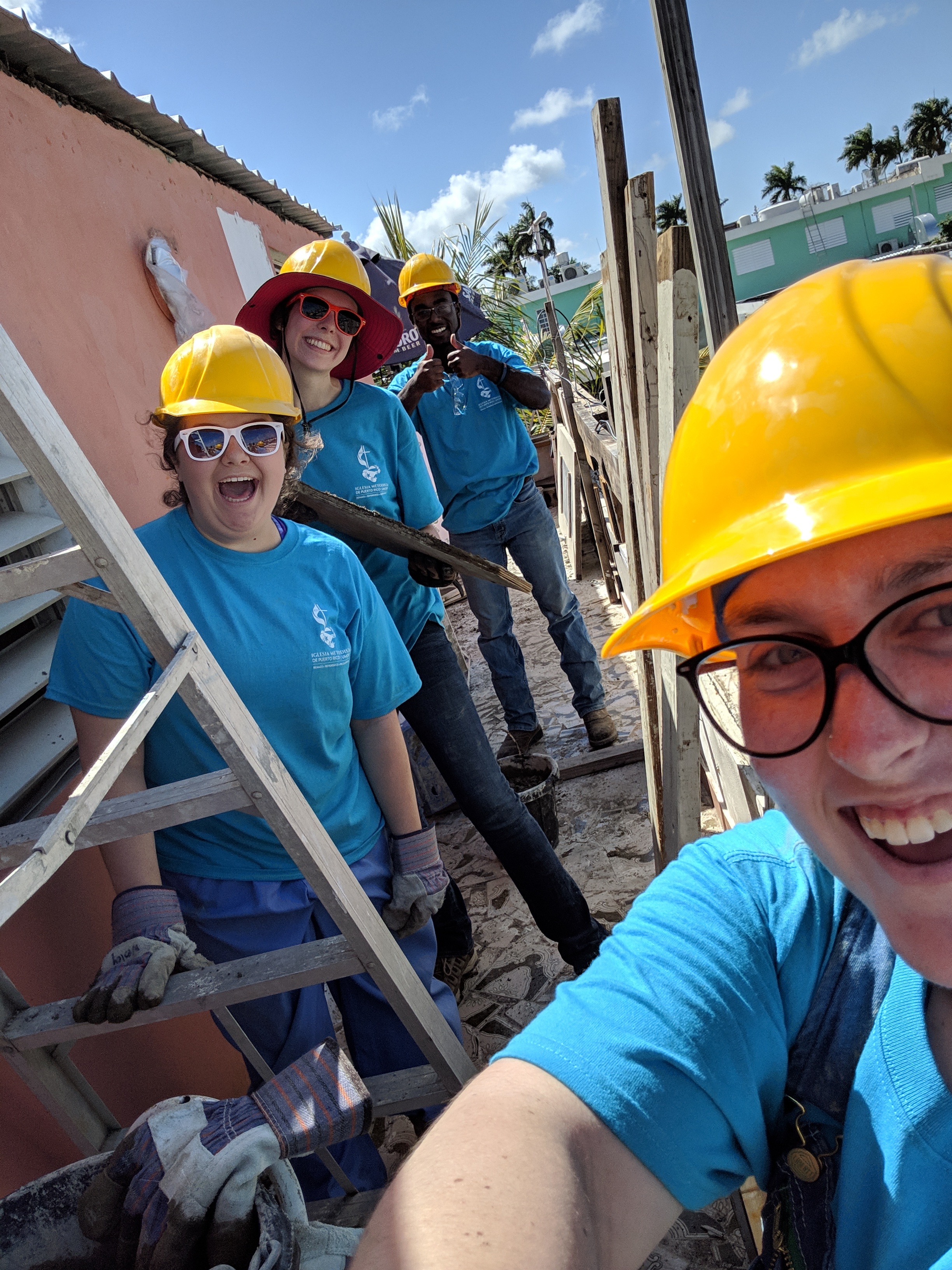 Taylor Vaughan, Sarah Jones, AJ Stanley, and Becca Mercer from Team 2 are shown smiling together before their day’s work was started. They spent most of the day doing rebar. Not pictured is Korie Burgess, who spent most of her day tearing out tile from the bathroom.