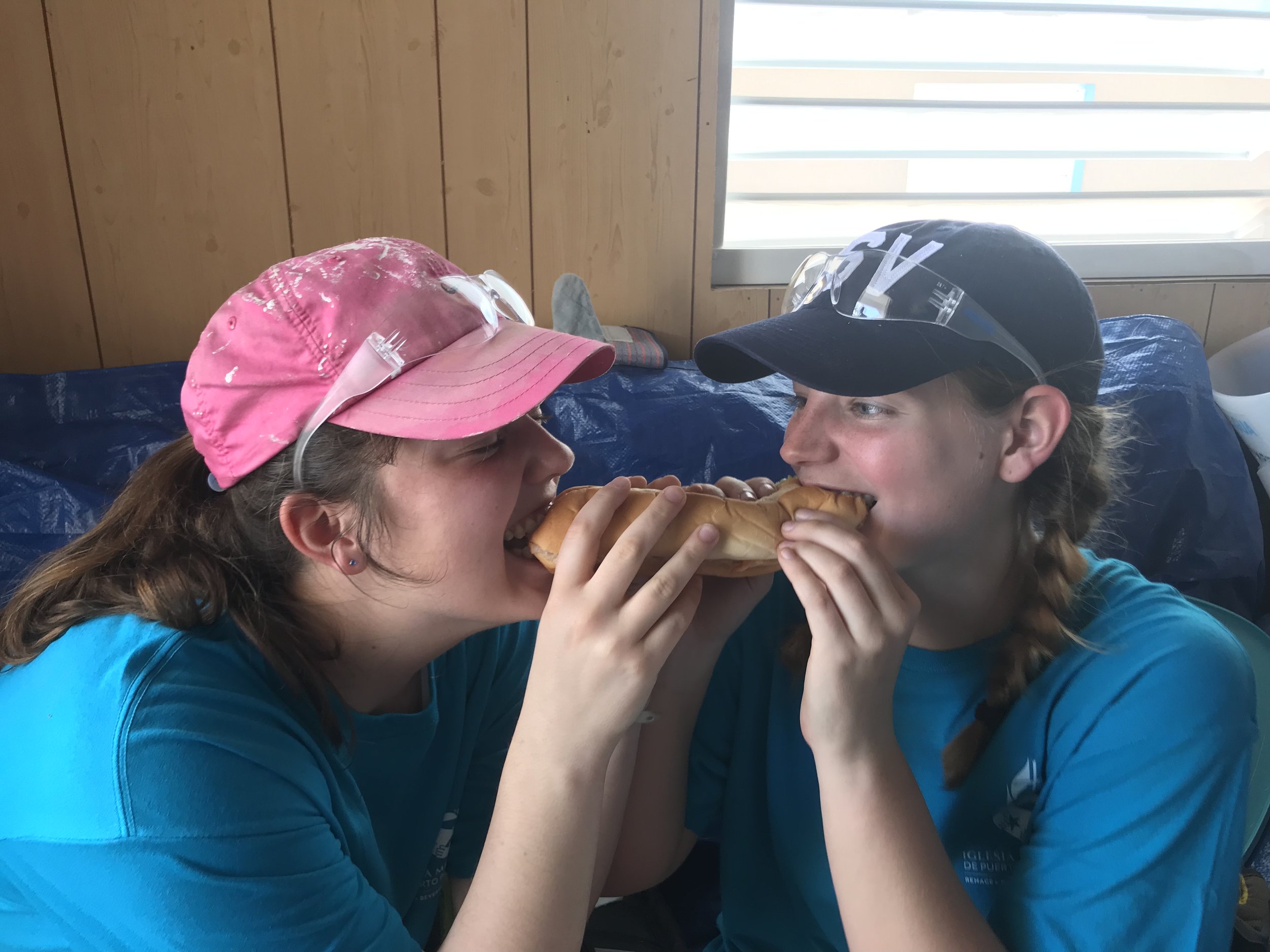Pictured above is Sarah Jane Thompson and Megan Kucera from Team 3, sharing a sandwich. Another team accidentally grabbed too many sandwiches, leaving Team 3 without lunches, a water cooler, or snacks. Luckily, some members of the host church scrambled to get more lunches and waters together for this team to eat lunch. Unfortunately, they were still a sandwich short, but Megan and Sarah Jane had a great attitude and volunteered to share a sandwich. Photo creds: Ben Gourley