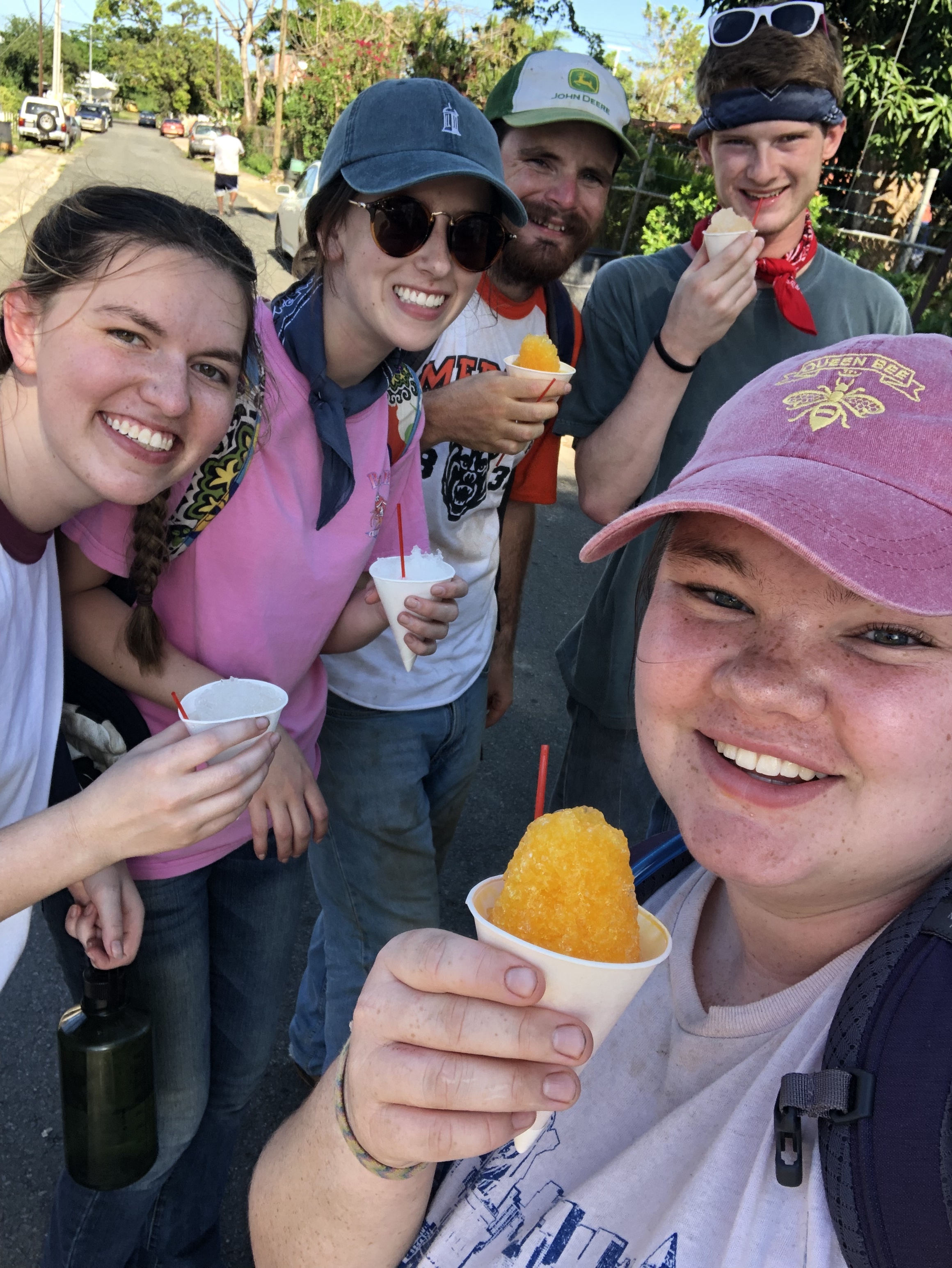 Lindsey Baird, Tatum Connell, JT Mercer, Richard White, and Becca Lamb smile as they got surprise snow cones from a local vendor after a long and hot day of work