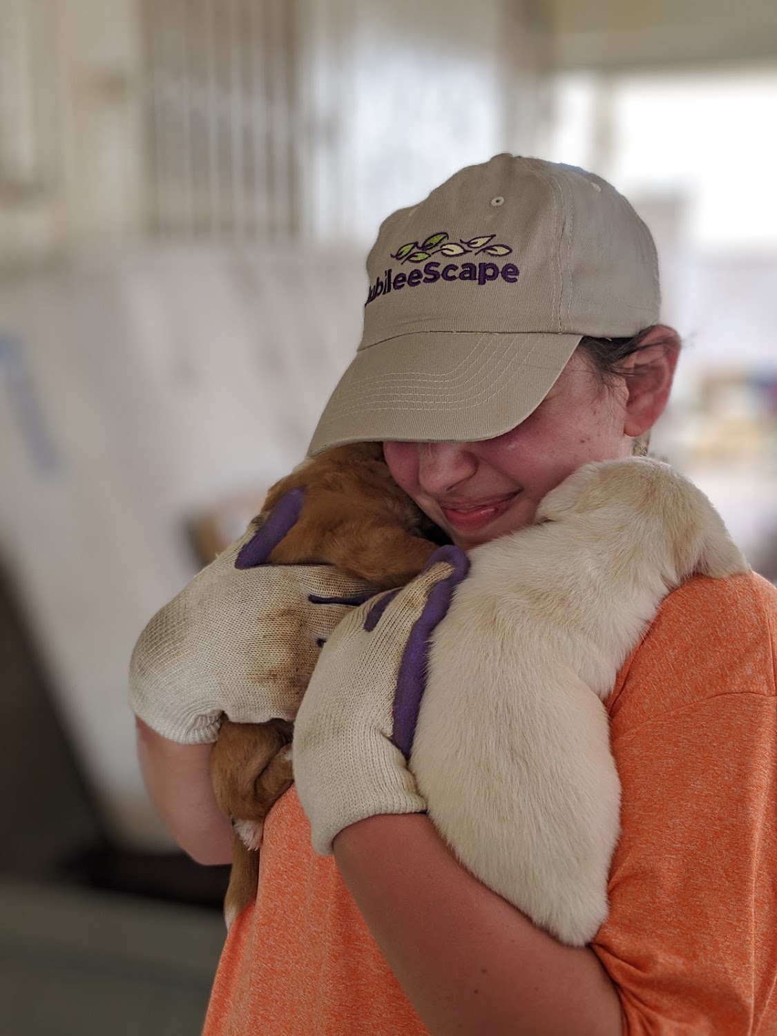 Korie Burgess from Team 2/ Agua de Coco is cuddling up to puppies after a day’s work