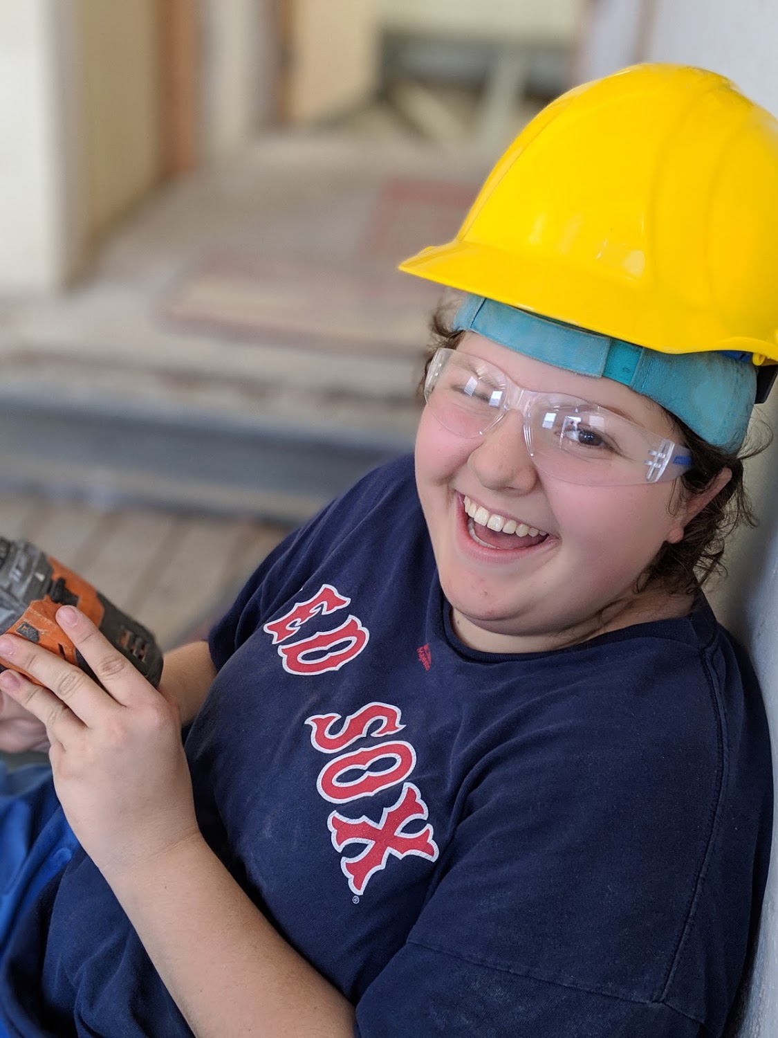 Taylor Vaughan from Team 2/ Agua de Coco is overjoyed to use the power drill to reinforce the concrete