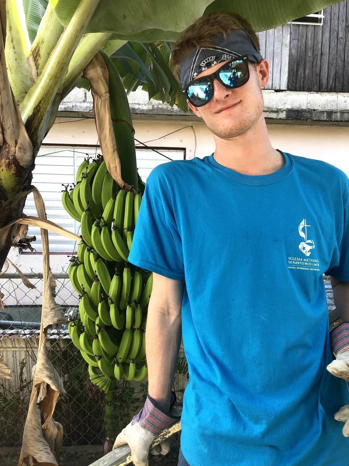 Richard White poses by a banana tree that was in the homeowner’s backyard. Photo creds to JT Mercer