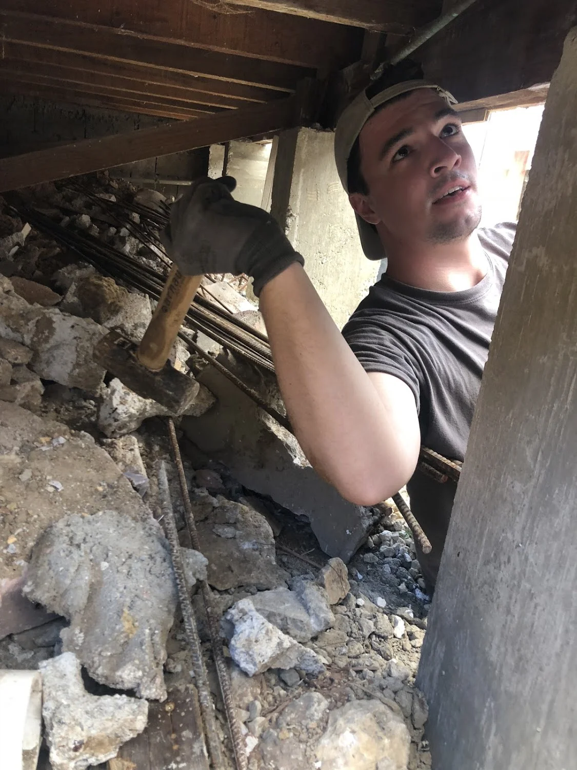 Josh Ellis takes a hammer to the under side of the house he was working on