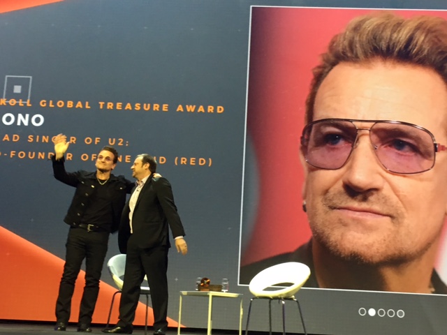 Bono accepting his award from Jeff Skoll. 