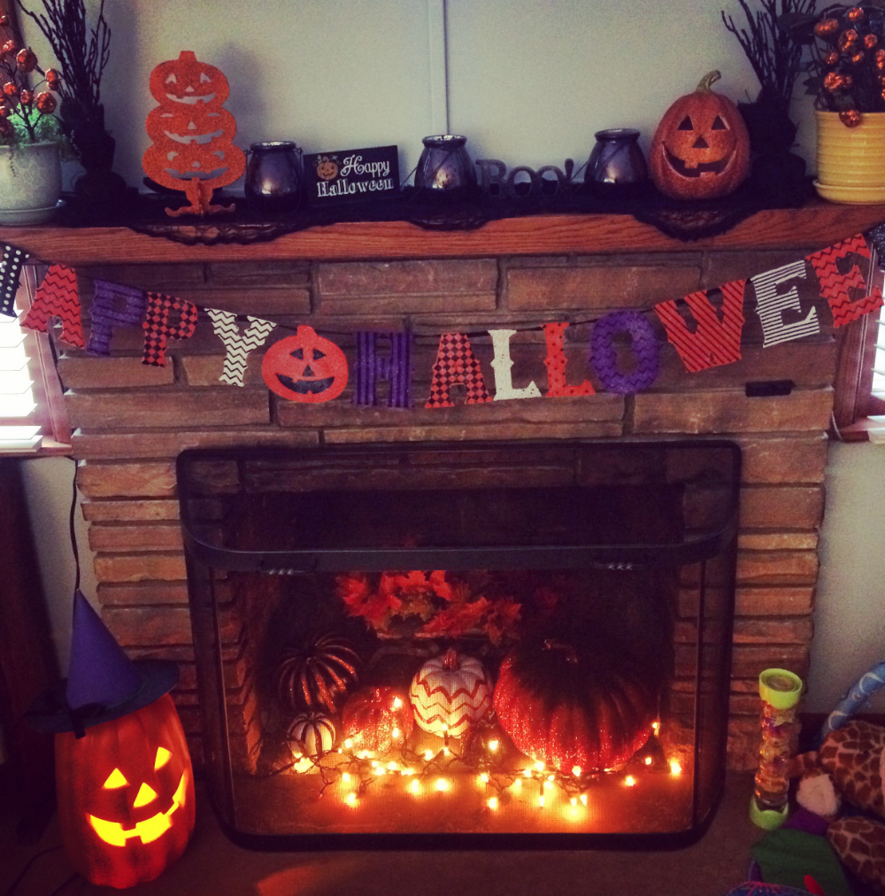 Mantles are great places to put decorations where your children can't destroy them. Notice my sparkly pumpkins behind a metal shield that has fallen on my son so many times he won't go near it. 