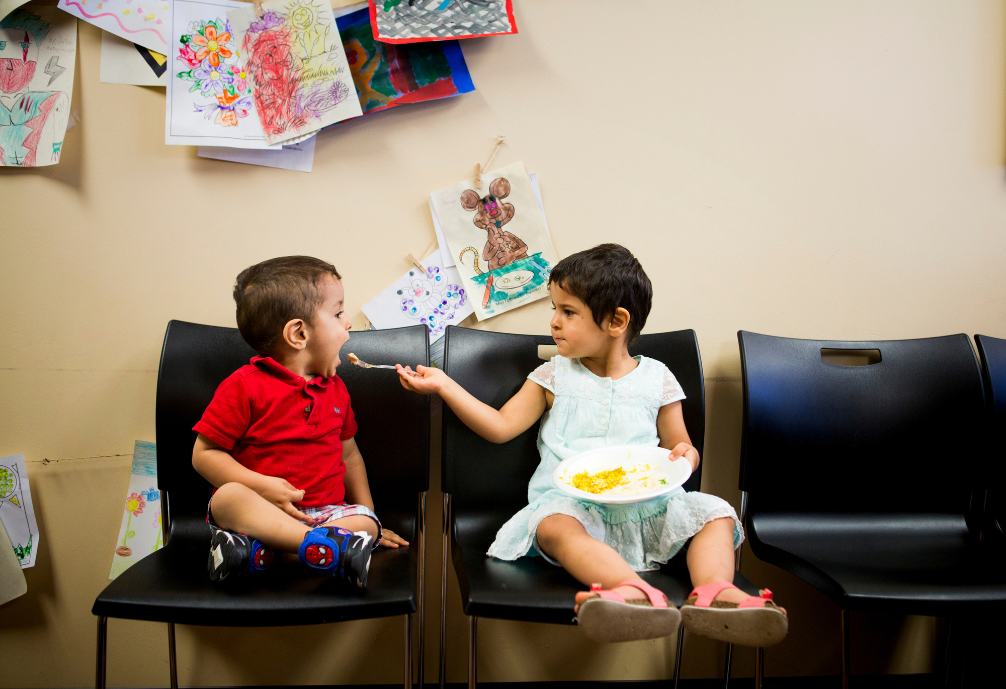  Ghalia Alhamoud feeds hummus to her brother, Yousif, at an Eid al-Fitr celebration at the Catholic Charities offices on Thursday, July 7, 2016. Eid al-Fitr marks the end of Ramadan fasting. 