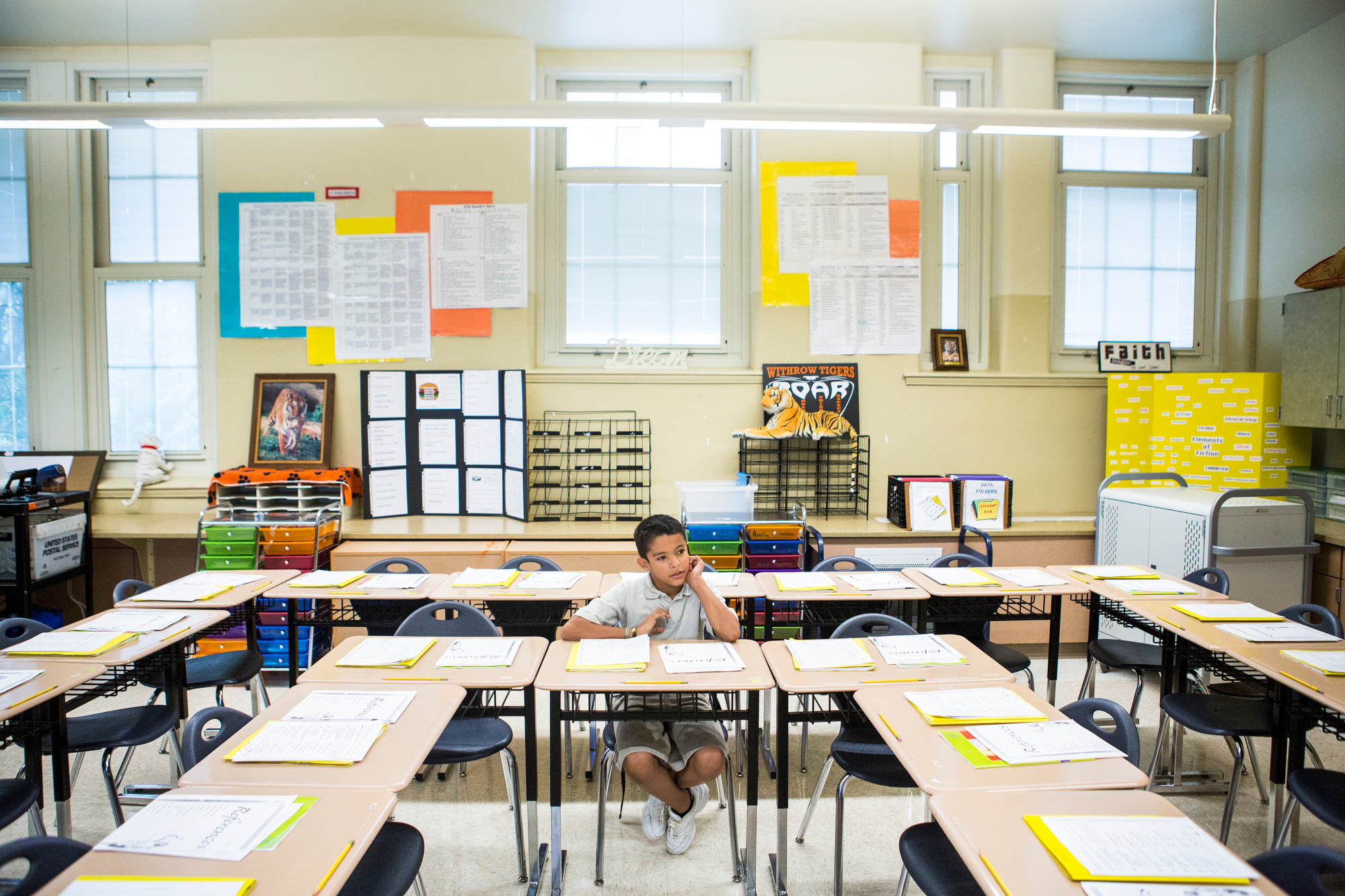  Hussein Alhamoud waits for his peers to arrive in class on the first day of school at Withrow University High School on Wednesday, August 17, 2016. 