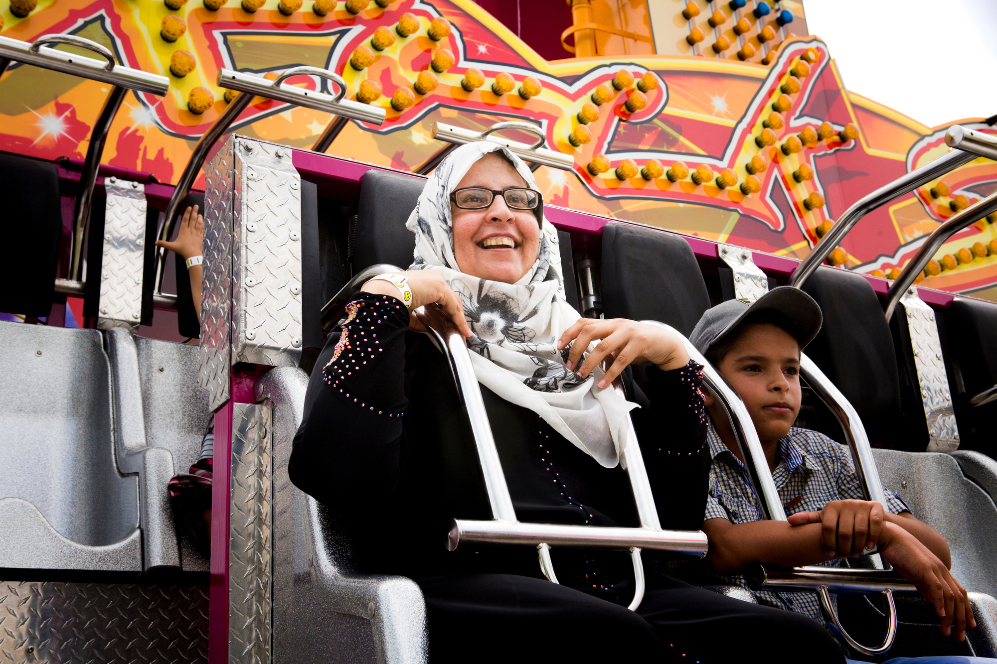  Ahlam and Hussein Alhamoud buckle into a ride at the Immaculate Heart of Mary parish festival on Sunday, July 17, 2016. 
