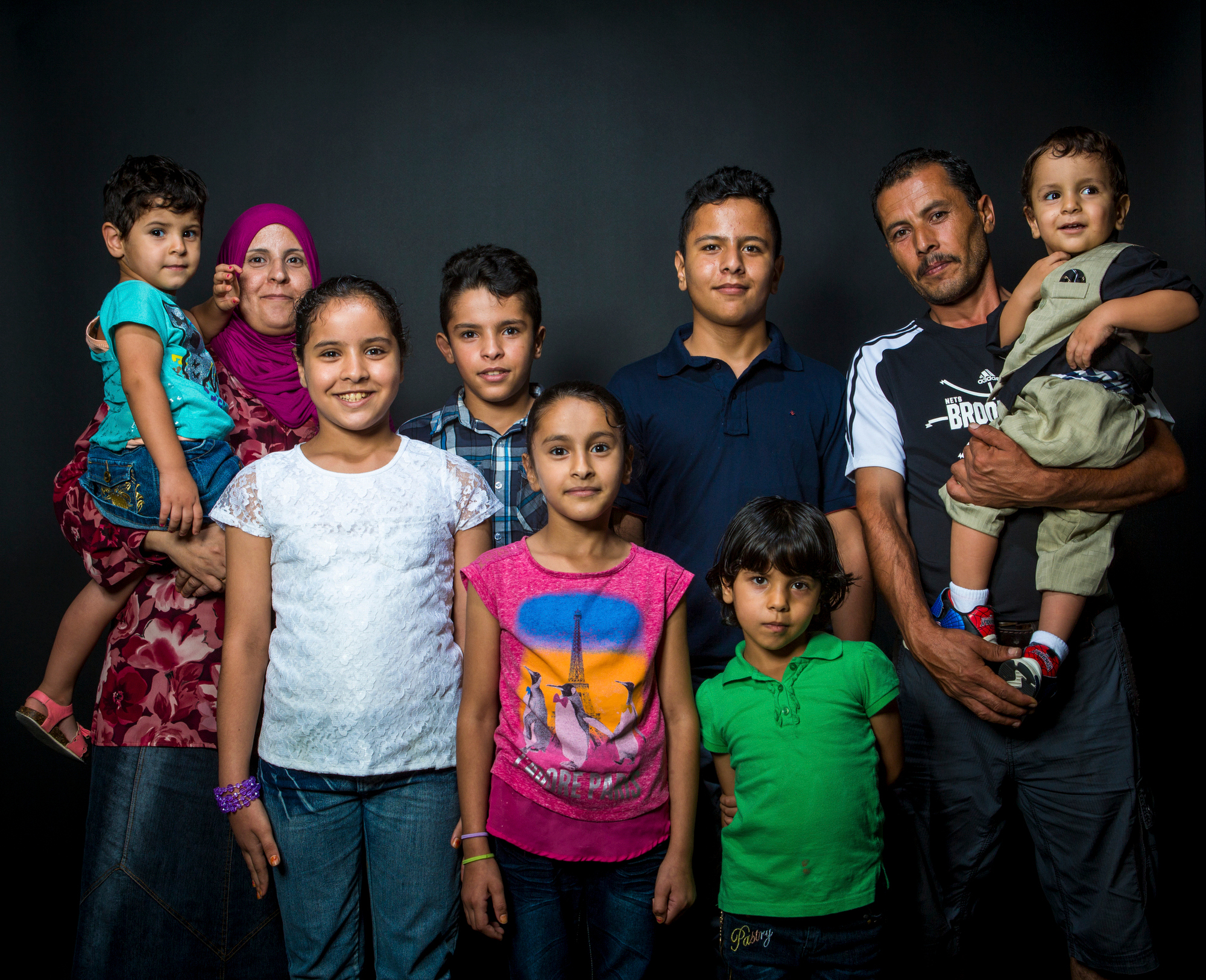  The Alhamoud family poses for a portrait on Sunday, September 25, 2016. They arrived in the United States on October 19, 2015, from Jordan, where they sought refuge for several years after fleeing Syria. Back row from left to right: Ahlam (36), Ghal