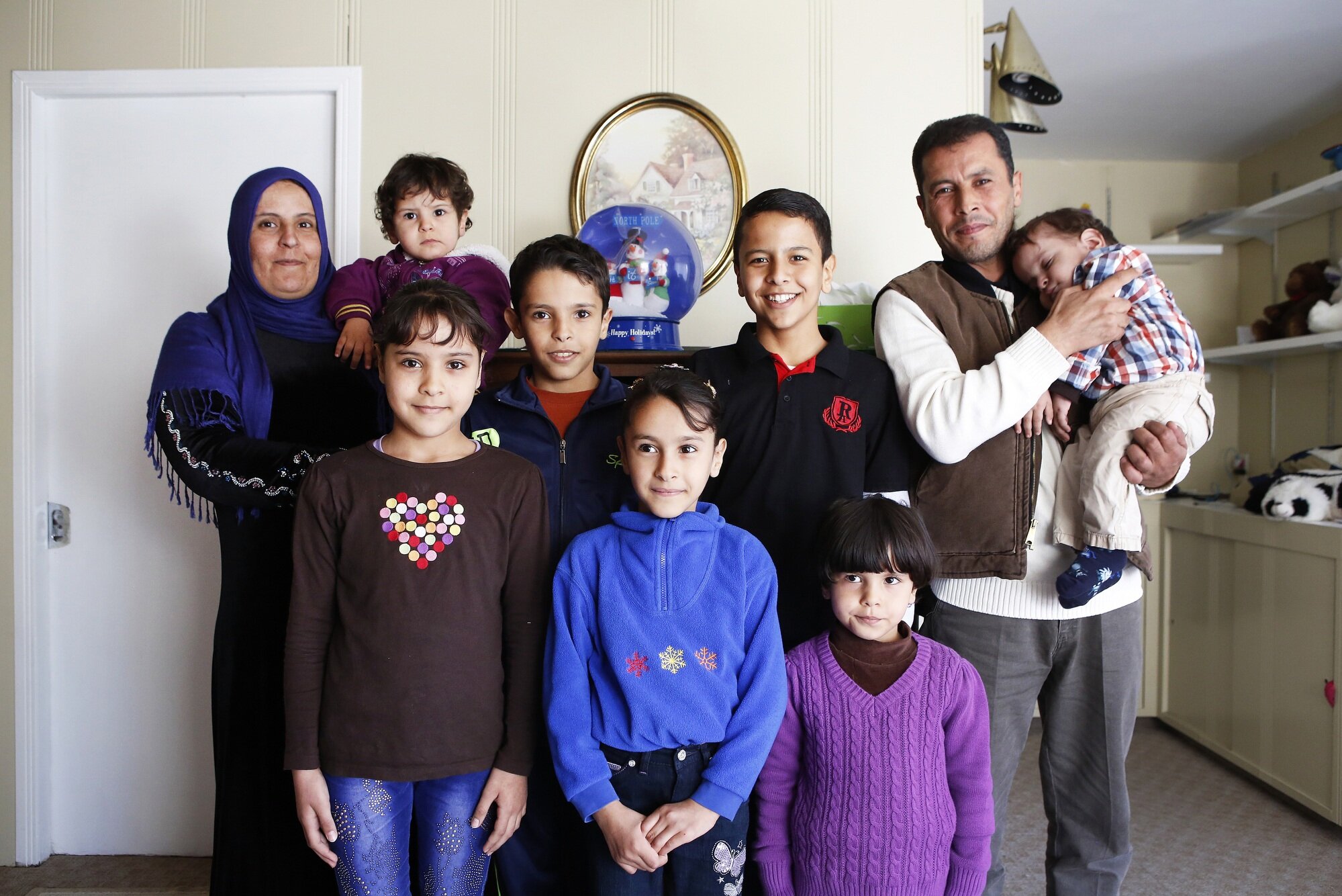  The Alhamoud family poses for a portrait in their home on Friday, November 13, 2015. They arrived in Cincinnati on October 19, 2015, from Jordan, where they sought refuge for several years after fleeing Syria. 