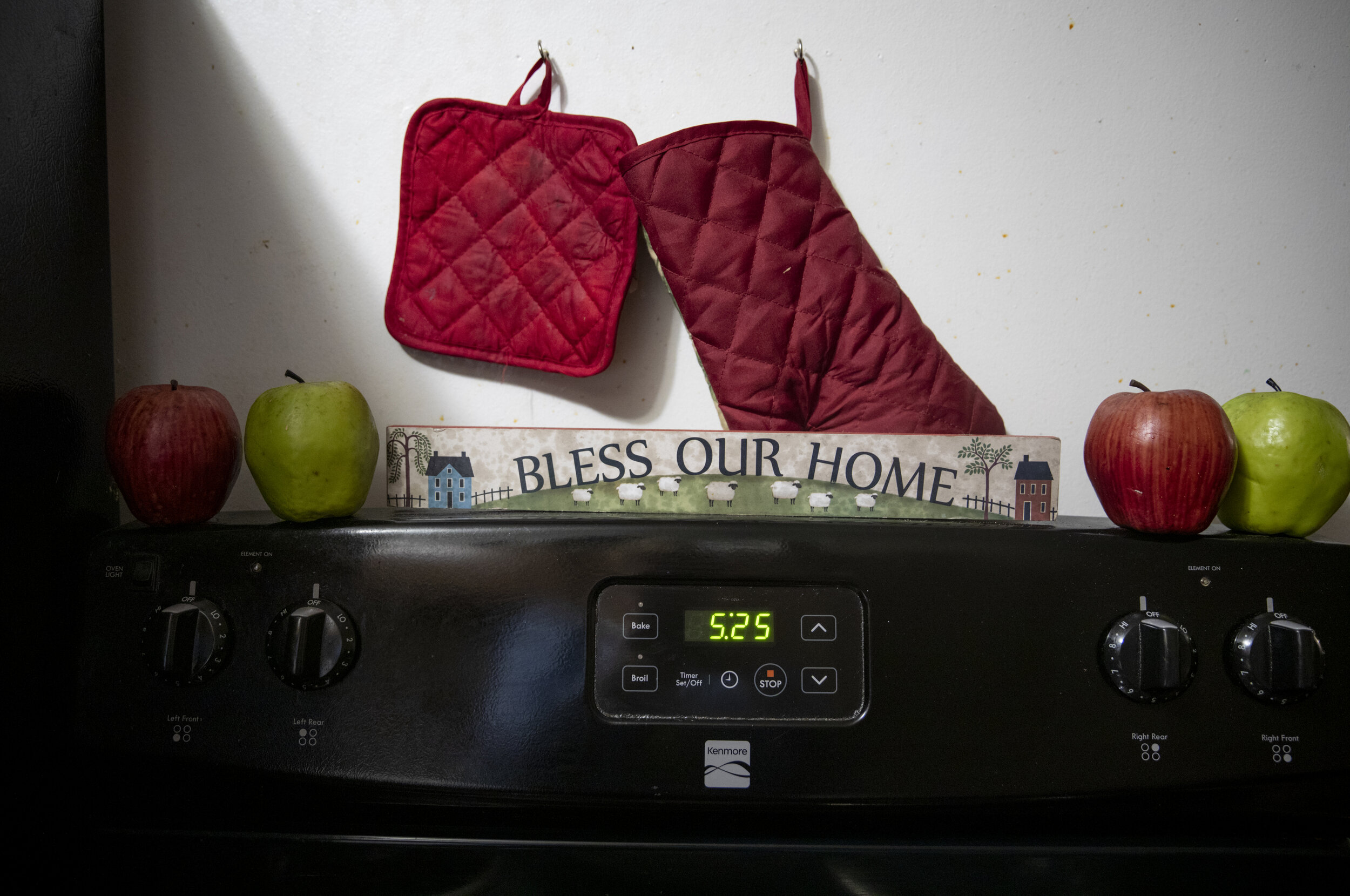  A "Bless Our Home" sign decorates the top of the stove in Paige Berry's home. 