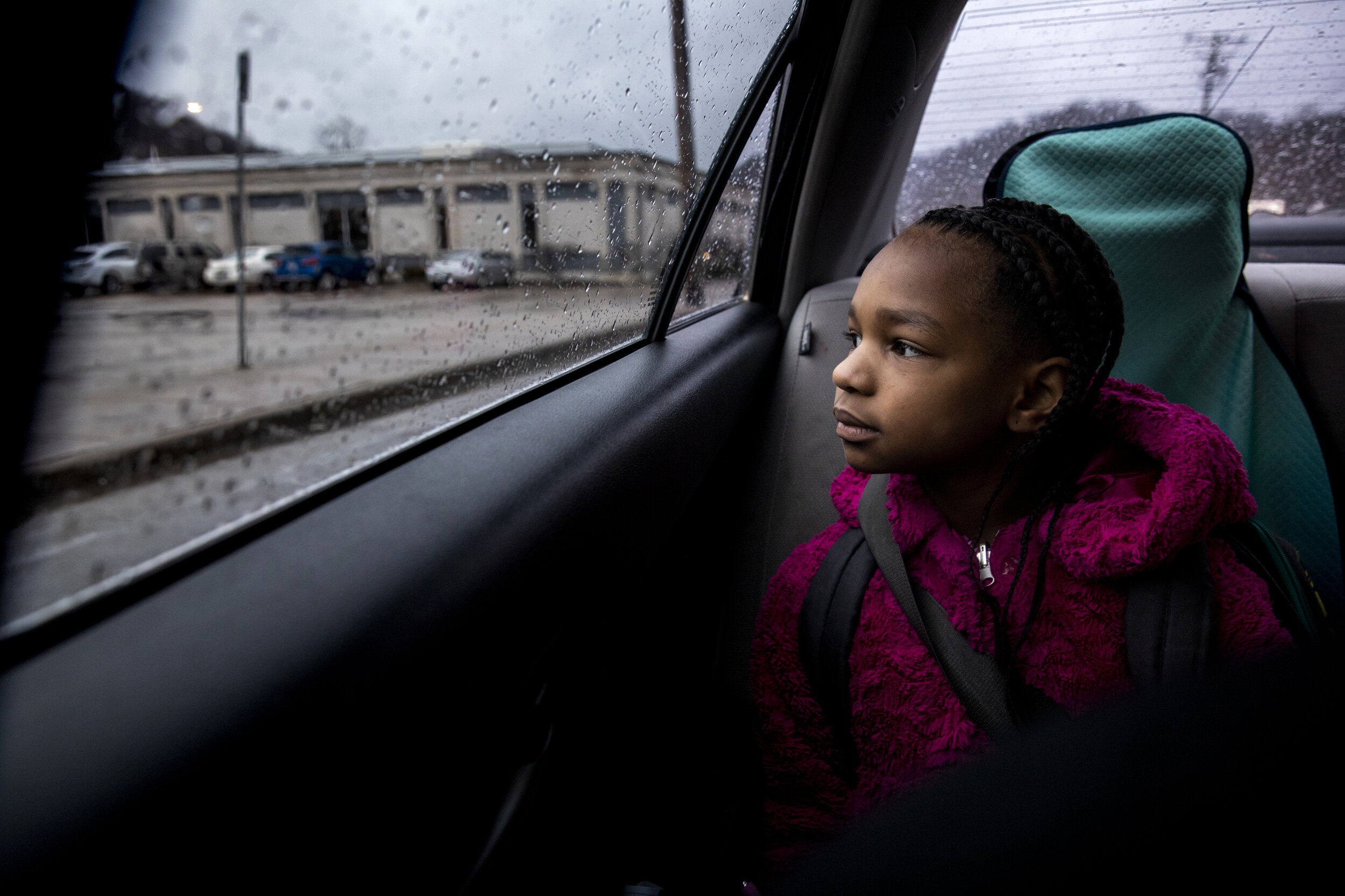  Amariyonna, 9, looks out the window as her mom drives her and her sisters to school in Northside. 