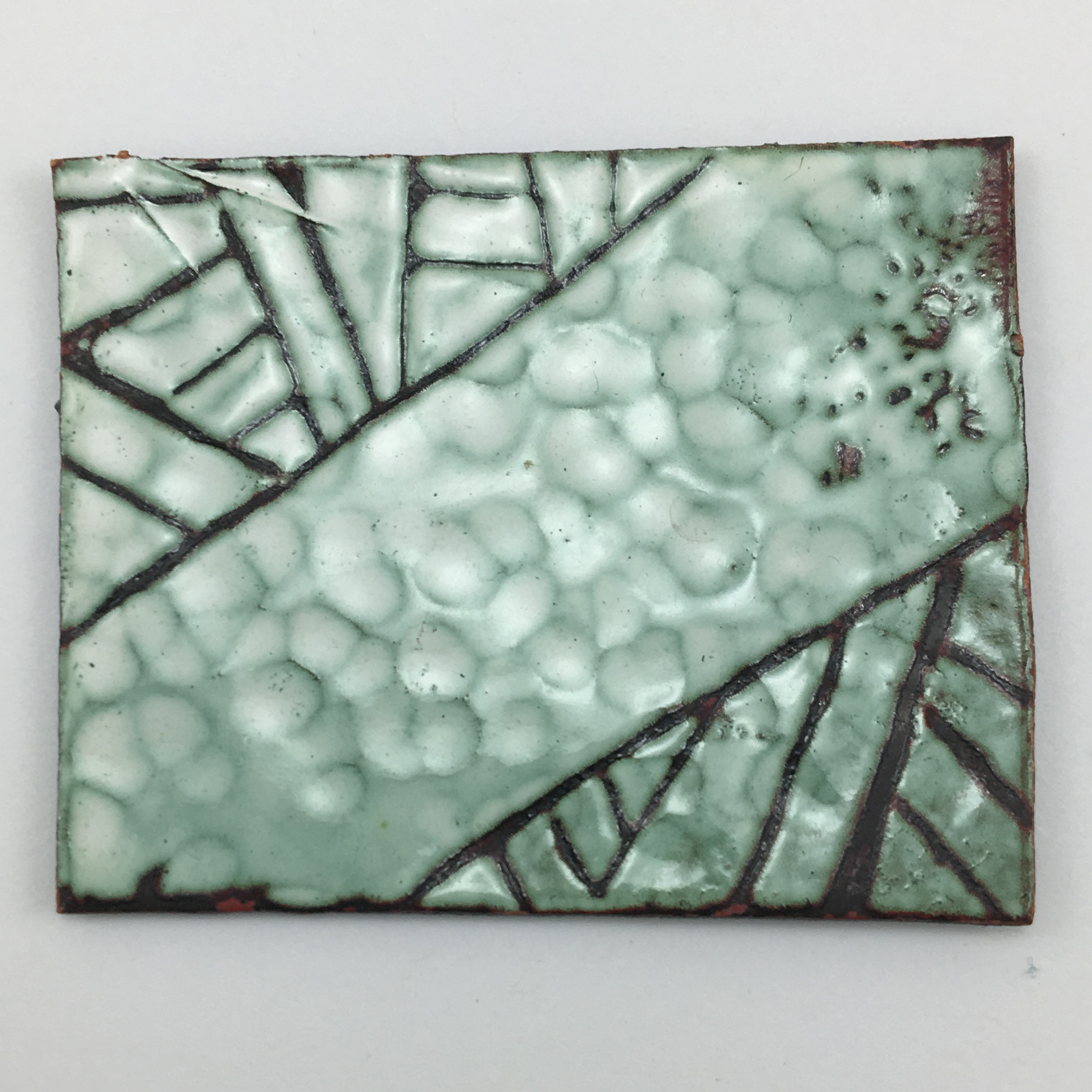 Exploring texture and sgraffito technique in white enamel.