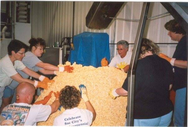 Members of the community creating the 1995 popcorn ball. Photo courtesy of the World's Largest Popcorn Ball on Facebook .