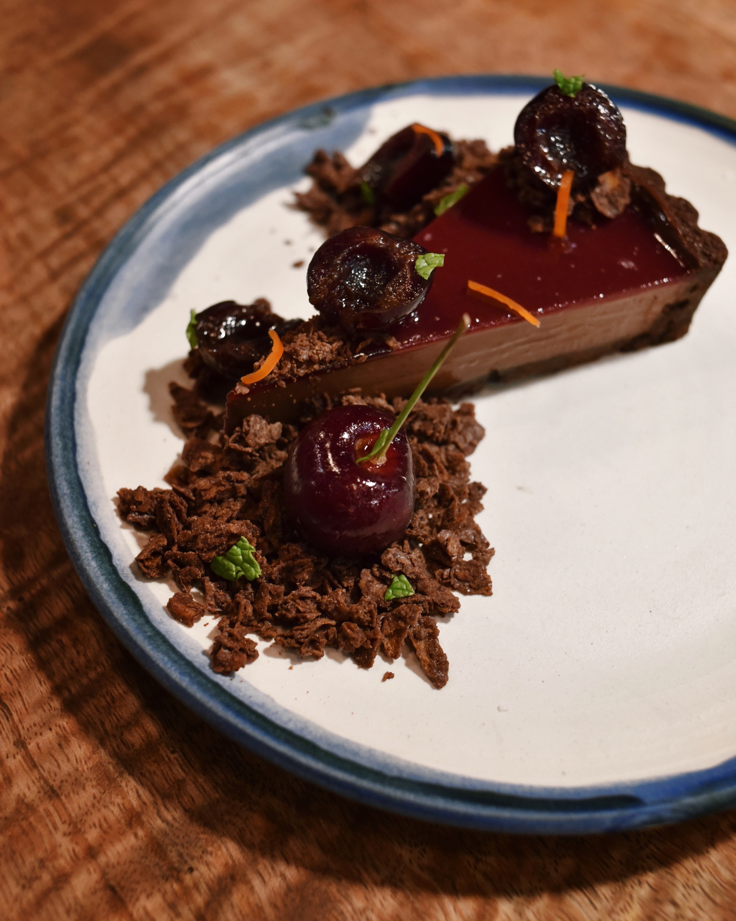 CHOCOLATE CHERRY OH BABY TART, valrhona dark chocolate cherry tart, compressed bing cherries in cacao and amaretto liqueur simple syrup, thai chili and chocolate salted feuilletine crunch