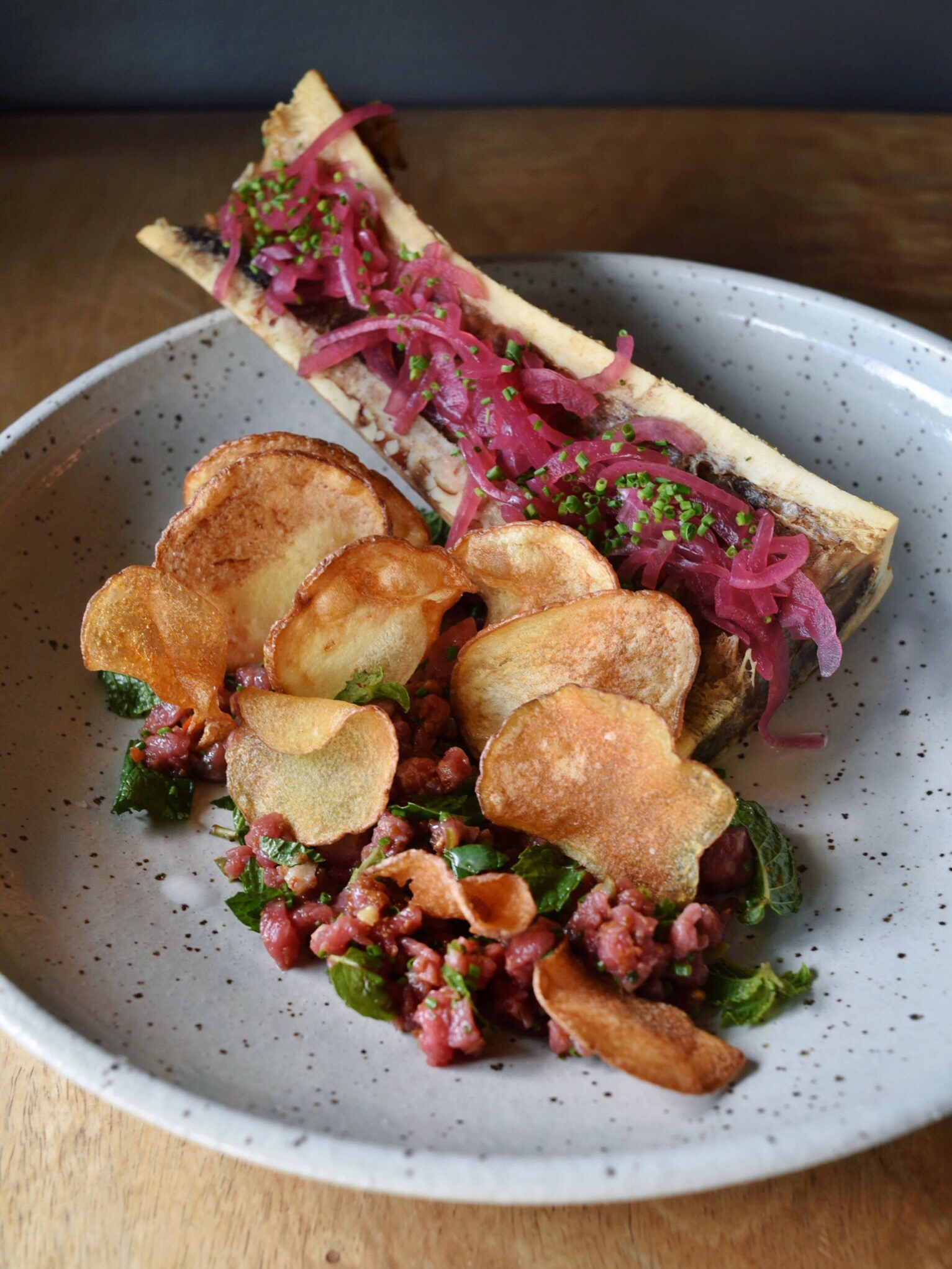 ROASTED BONE MARROW & BEEF TARTARE, PICKLED RED ONION, FRIED GARLIC, MINT, HAWAIIAN CHILI, RED BOAT FISH SAUCE, CHIPS