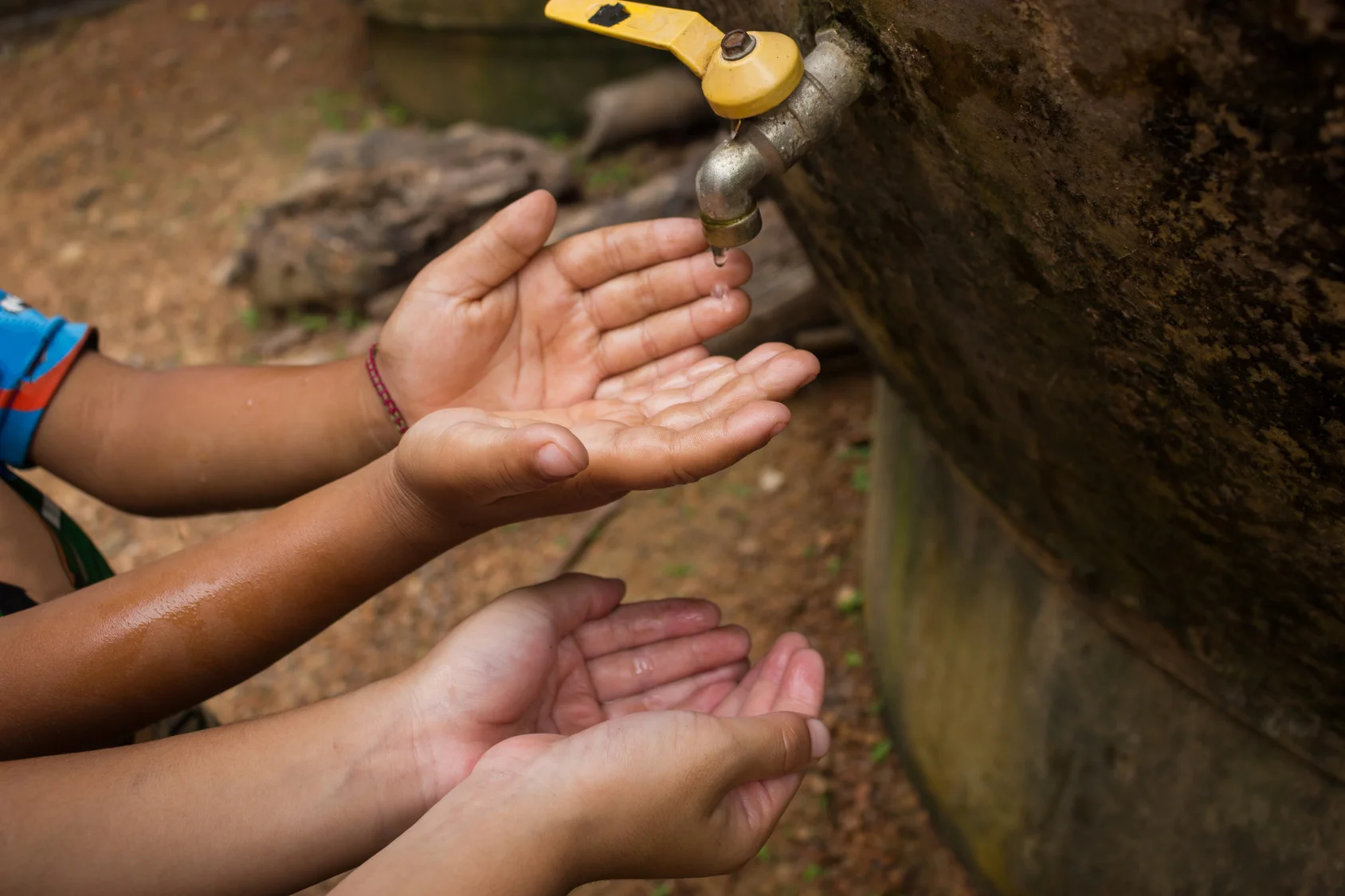 Childrenshandswaterdrop.jpg