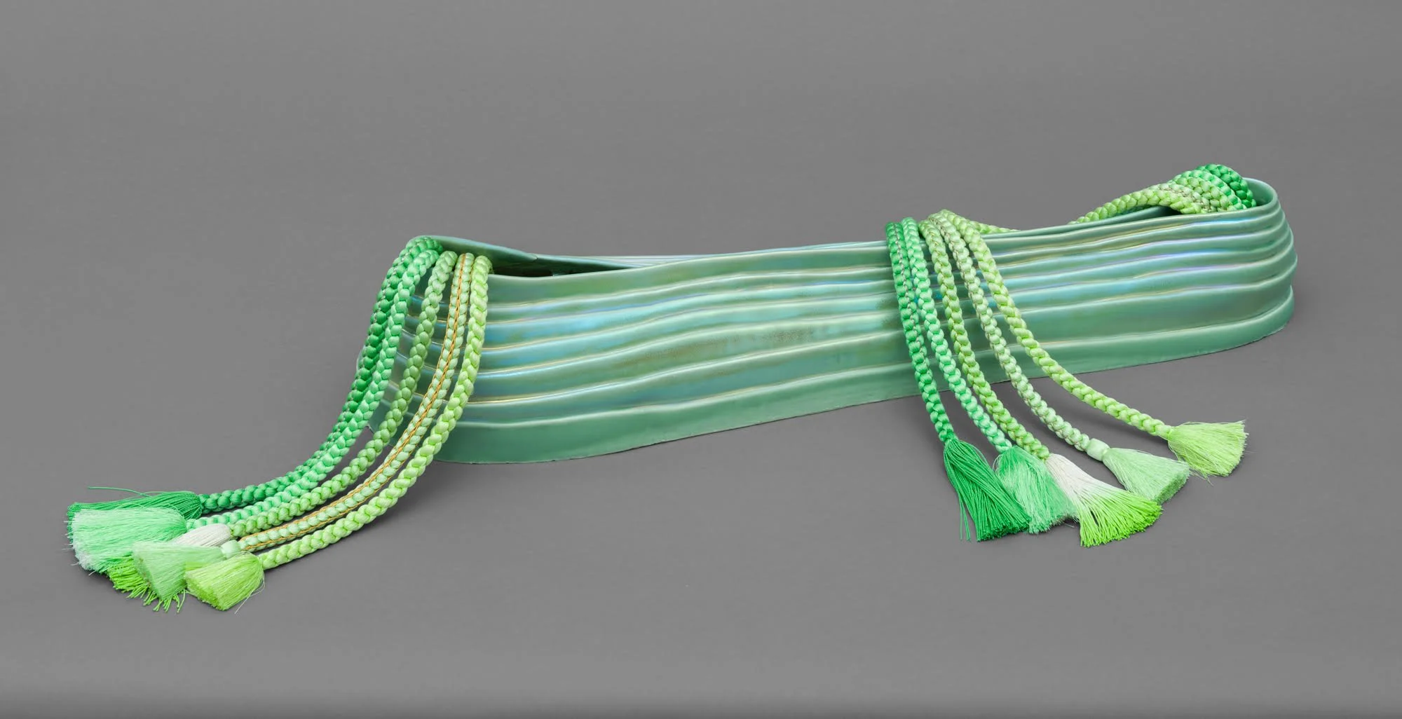   Mudai I , 2026 Porcelain, Glaze, Pearl PVD, Kumihimo&nbsp; 6 × 32 × 17 inches 