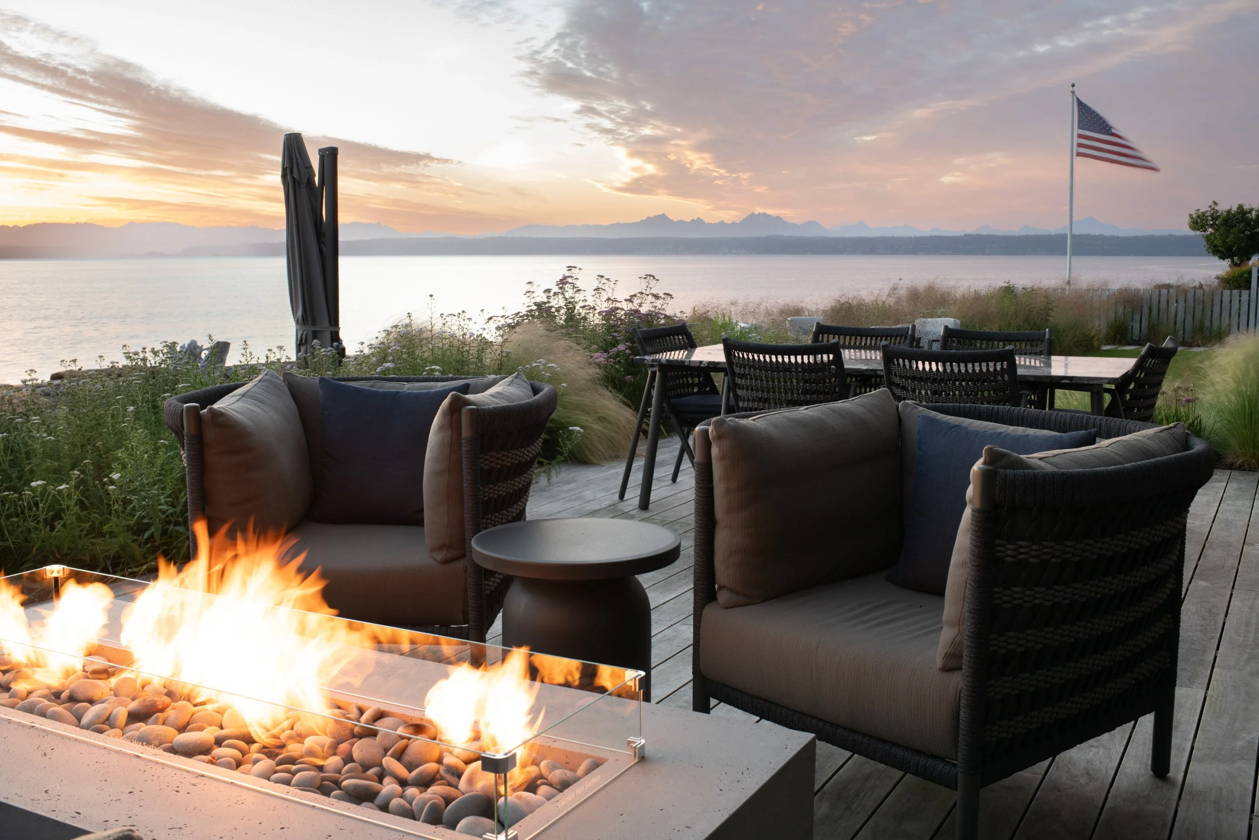 A fire feature and two chairs with Puget Sound in the background.
