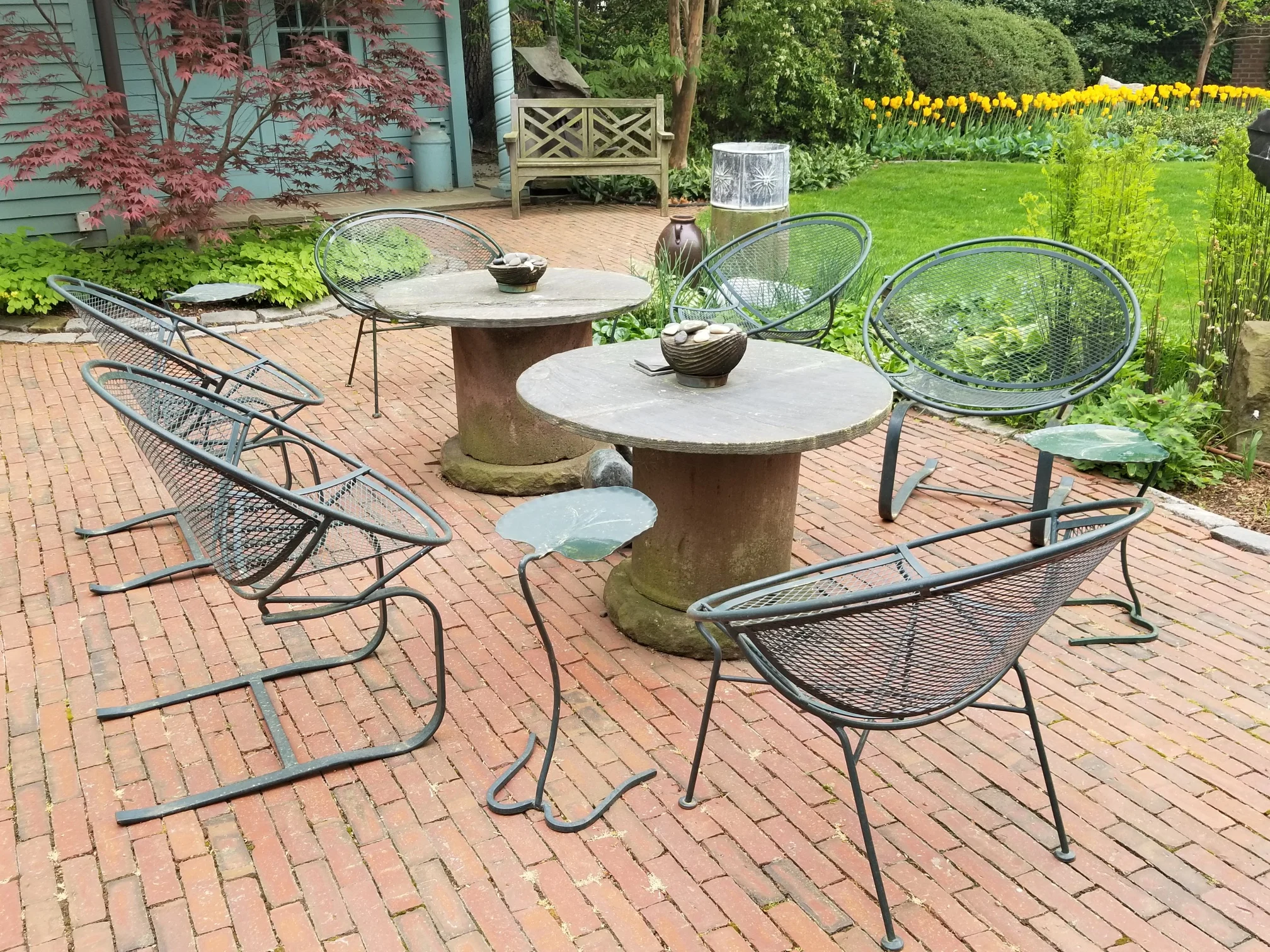 This collection of “Radar’ Hoop chairs has a definitive mid-century feel. Note the Salterini leaf lily pad tables too!