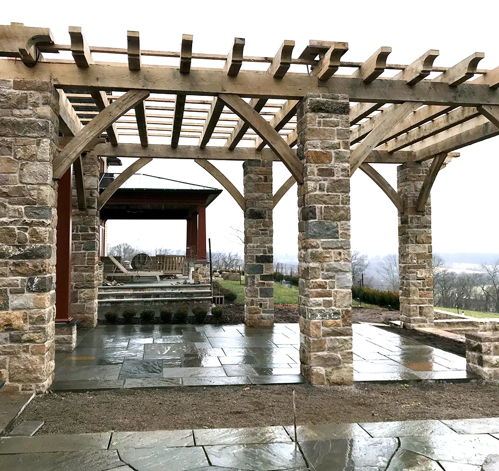 The Arbor over the dining terrace: materials are big and bold: 24x24” stone columns and rough cut timbers.