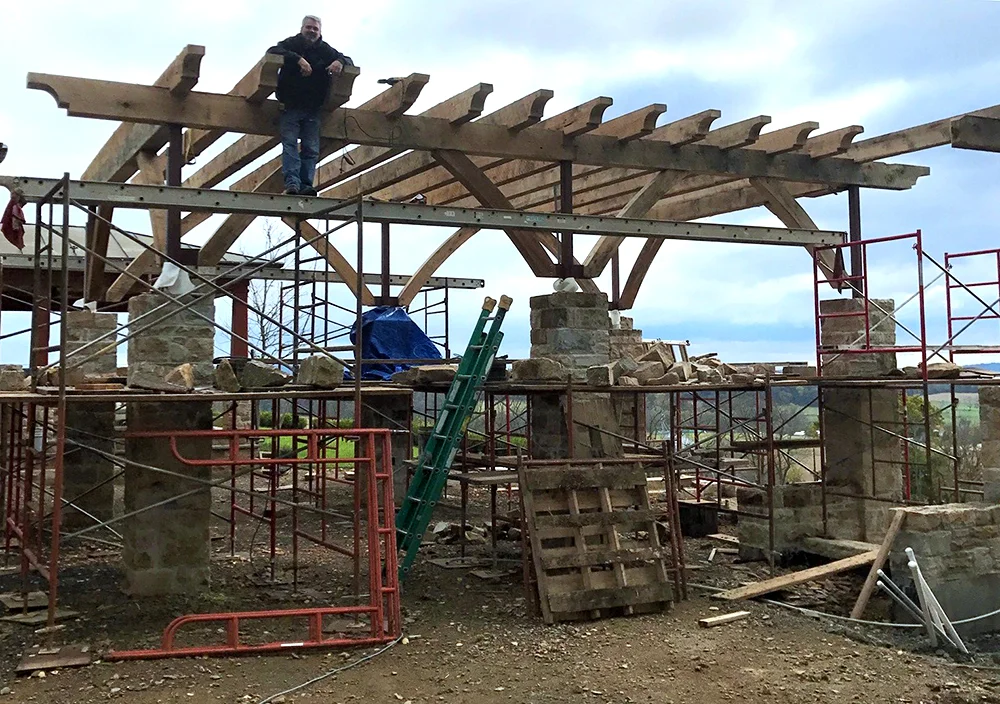 The arbor under construction and contractor Glen Mayer taking in the view from above.