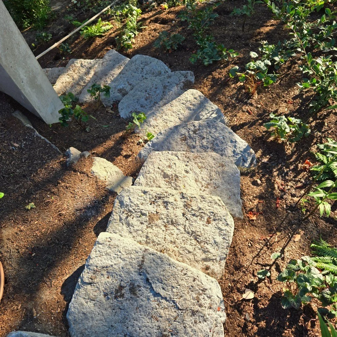 This stone stairway leads to a hidden side entry. Our steeply sloped landscapes often call for creativity. Here, landscape contractor @NussbaumGroup placed anchors for securing a rope, making it possible to plant safely on challenging terrain.