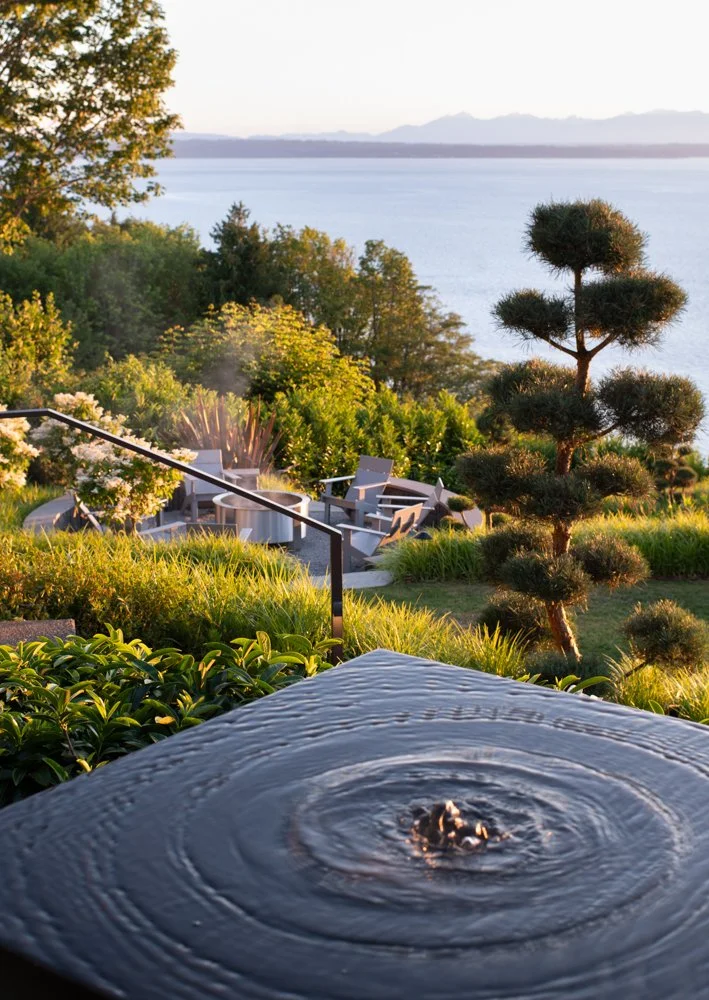 Remembering golden summer evenings in the garden&mdash;where water, stone, and sky come together in quiet harmony. Our fire terrace is encircled with repurposed stone, creating a warm gathering place around the wood-burning fire feature. Gratitude fo