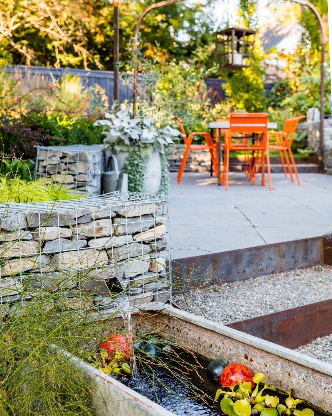An eclectic, industrial sensibility shapes Gillian&rsquo;s Garden in Seattle. 

Layered terraces are defined by gabion walls that retain the sloping site while introducing texture and material contrast throughout the garden. Weathering steel edges an