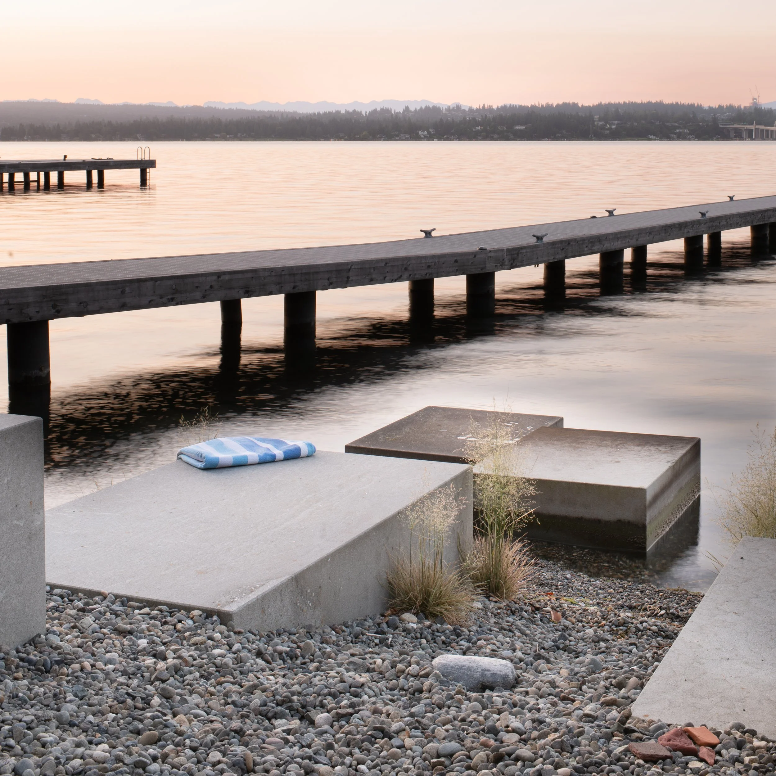 At Shore Blocks honed stones placed on the beach and in the water attenuate wave action at different water levels and provide spaces for lounging and playing at the water’s edge.