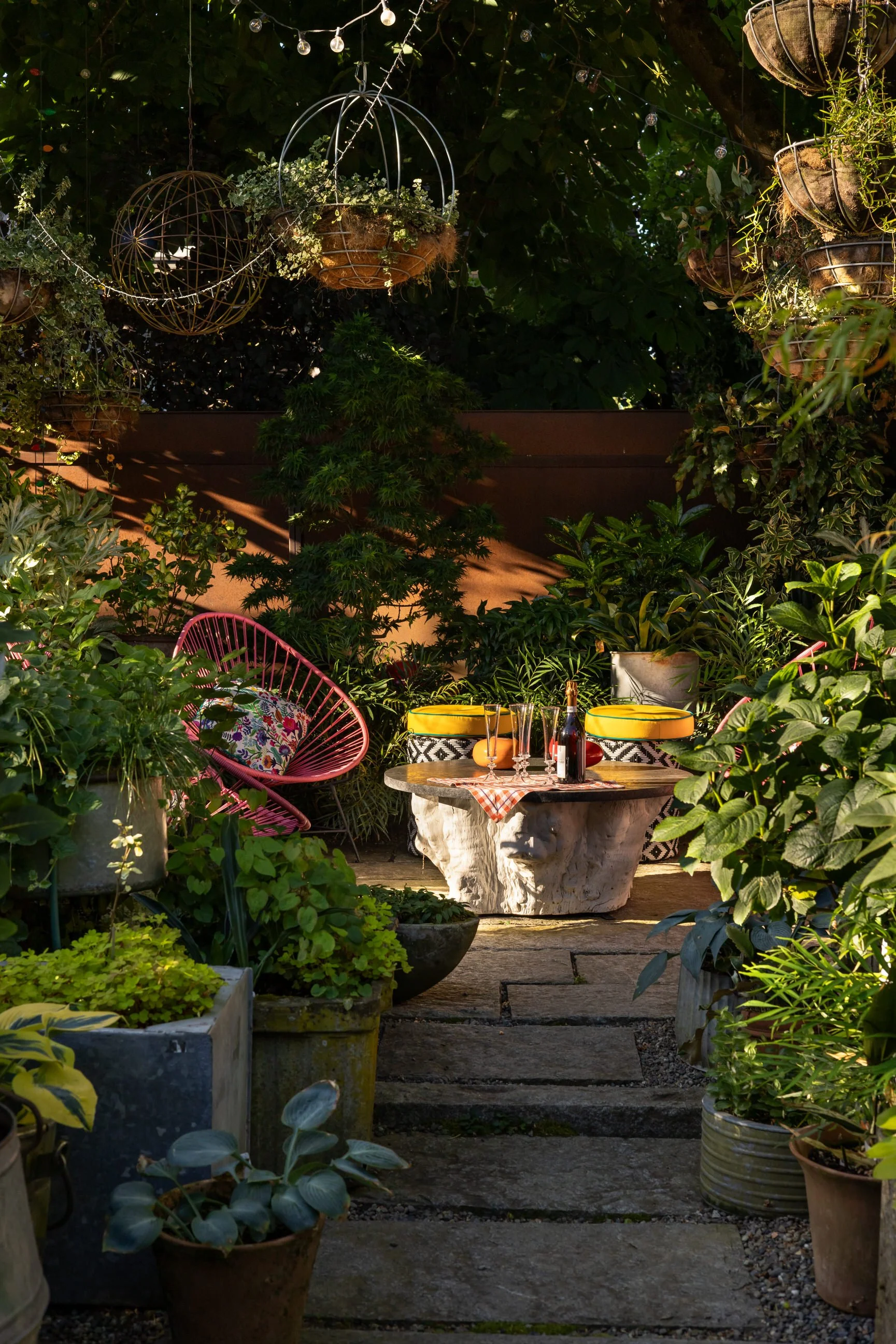 A view into the outdoor living area under the chesnut tree.  Hanging baskets float above.