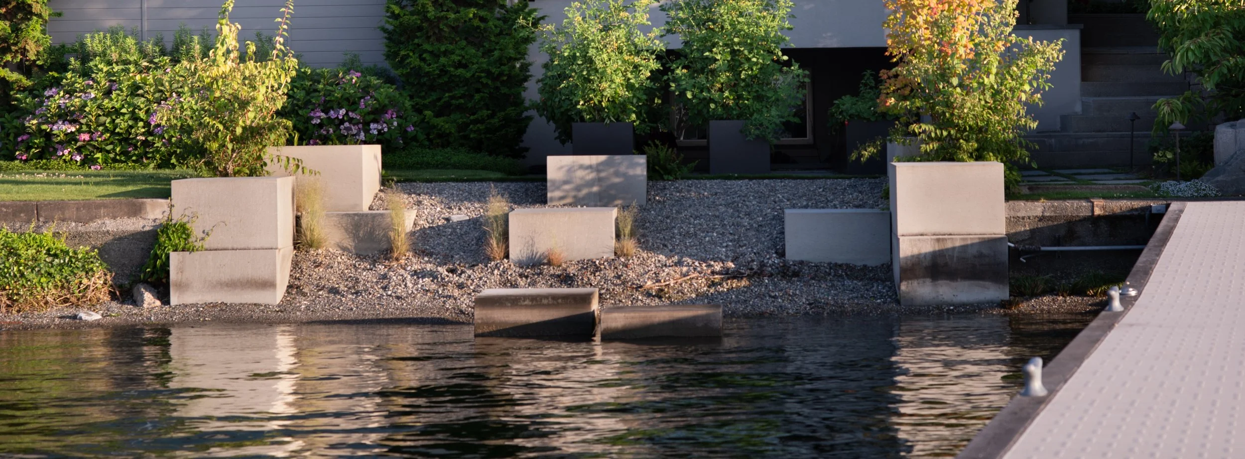 At Shore Blocks honed stones placed on the beach and in the water attenuate wave action at different water levels and provide spaces for lounging and playing at the water’s edge.
