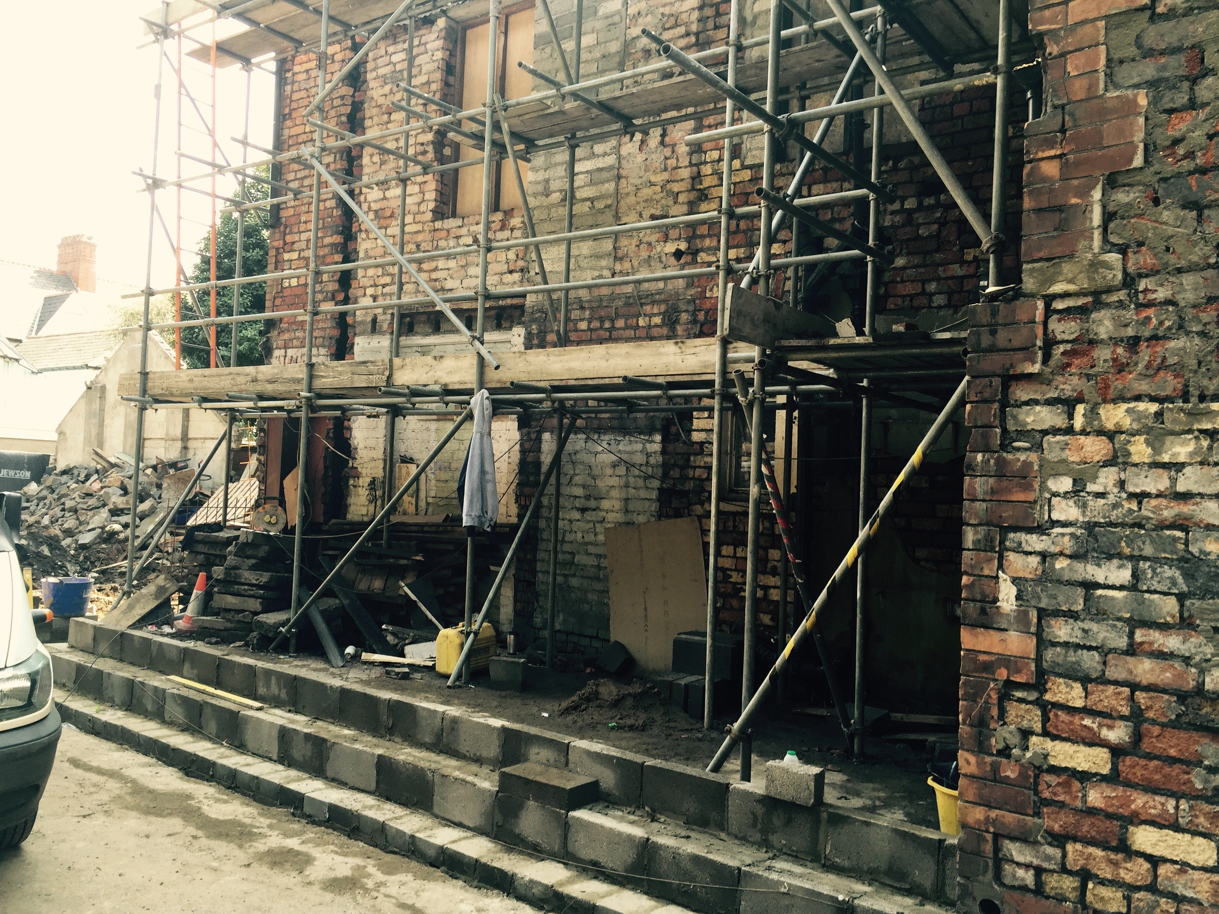 Existing side extension demolished and new glass roof extension walls going up.