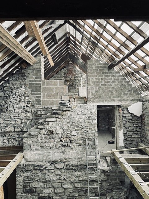 The stripped out rooftiles and exposed stone give an almost ethereal atmosphere to the new double height atrium
