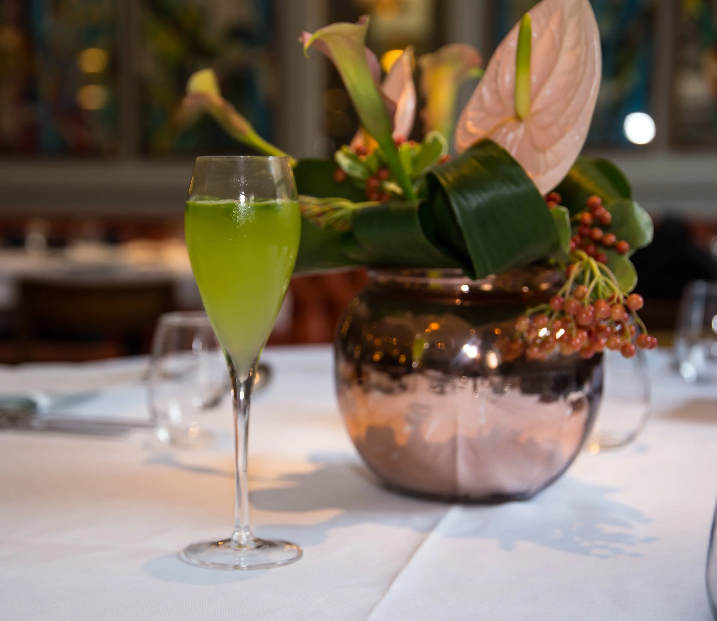Norfolk 75 welcome cocktail – Boadicea Classic gin, lemon juice, sugar syrup, fresh basil leaves all shaken and fine strained and topped with Ivy Champagne with garnish of micro basil