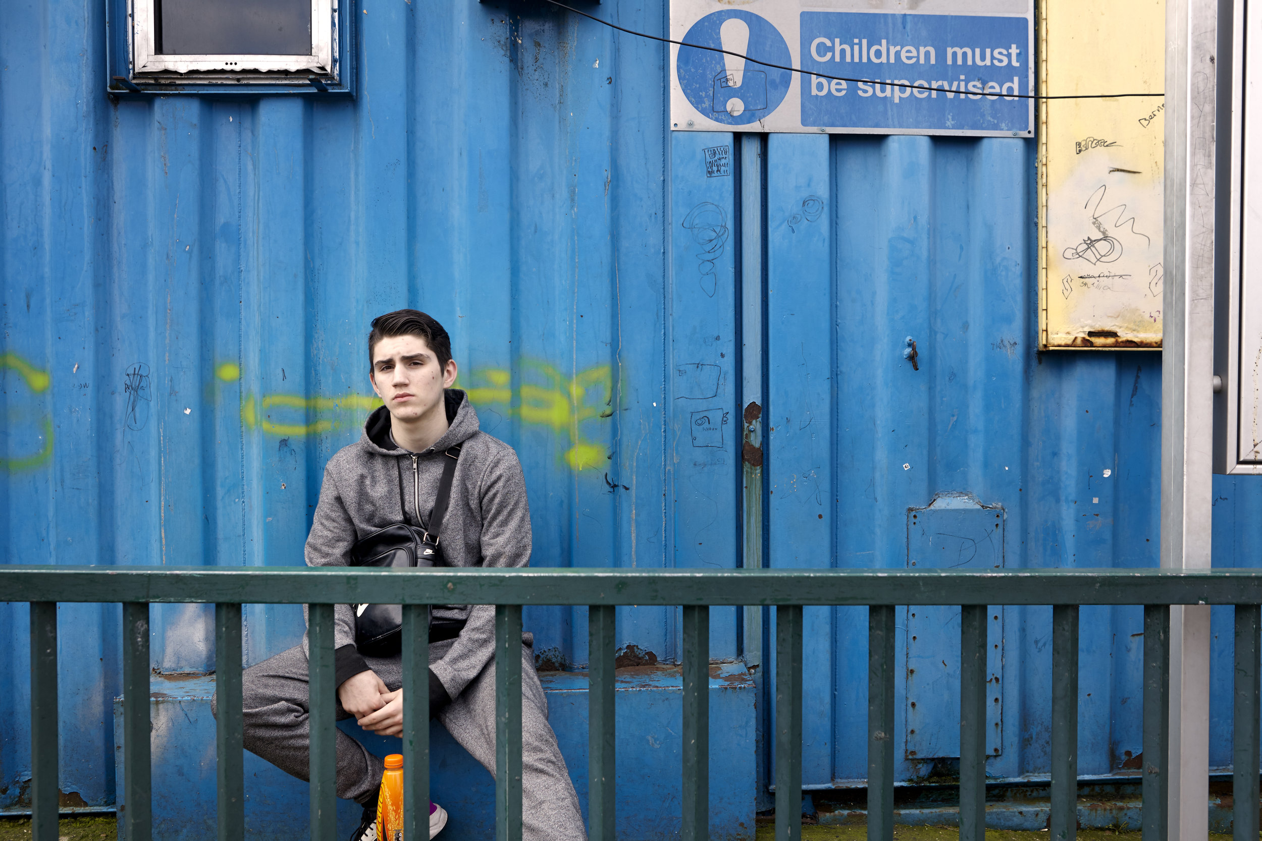  Jerry (13) sits in front of the site’s makeshift school building. Living on a traveller’s site in Catford, I ask him about his feelings towards living on a site: “It’s good. It’s freedom! Basically it’s all we really know is living on site. I used t