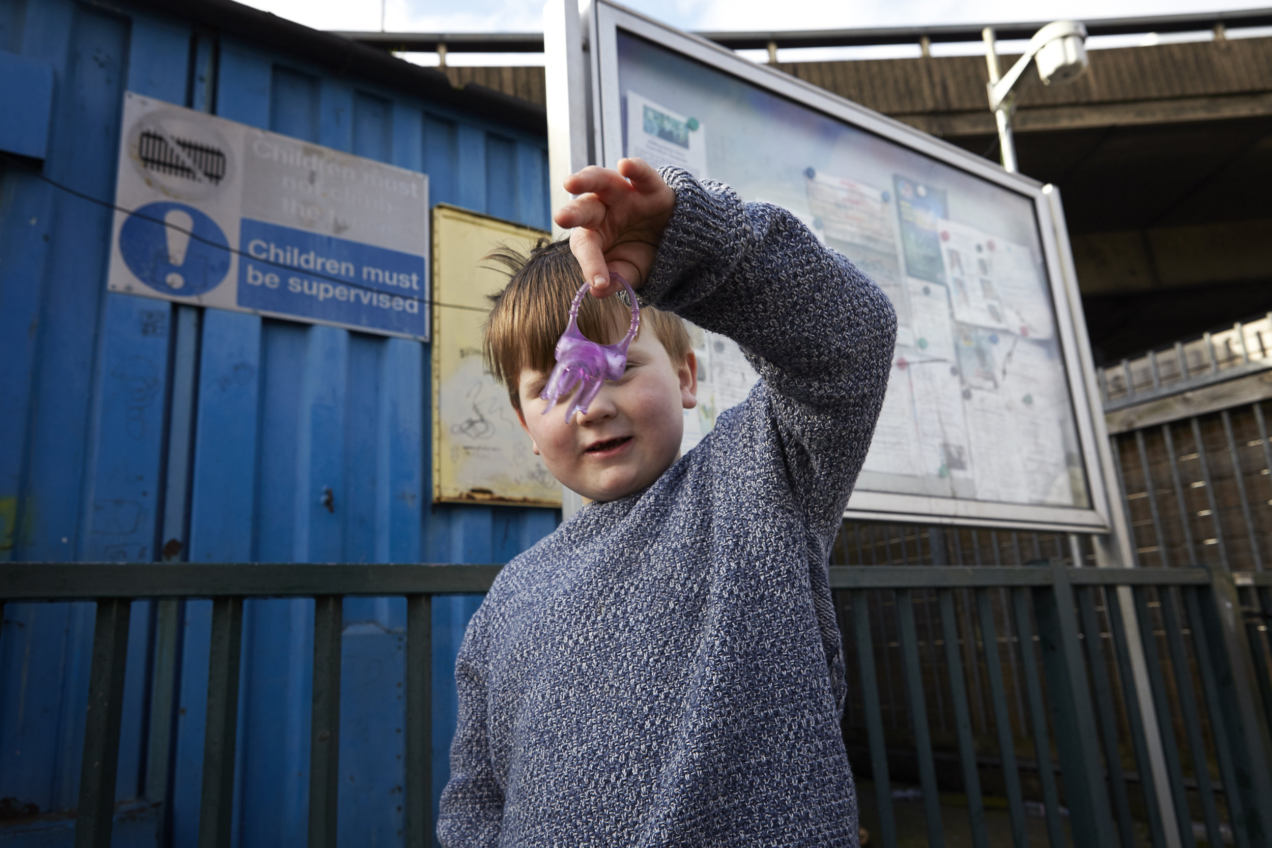  One of the children on the site holds up a toy he found lying around during the half term break.&nbsp; 