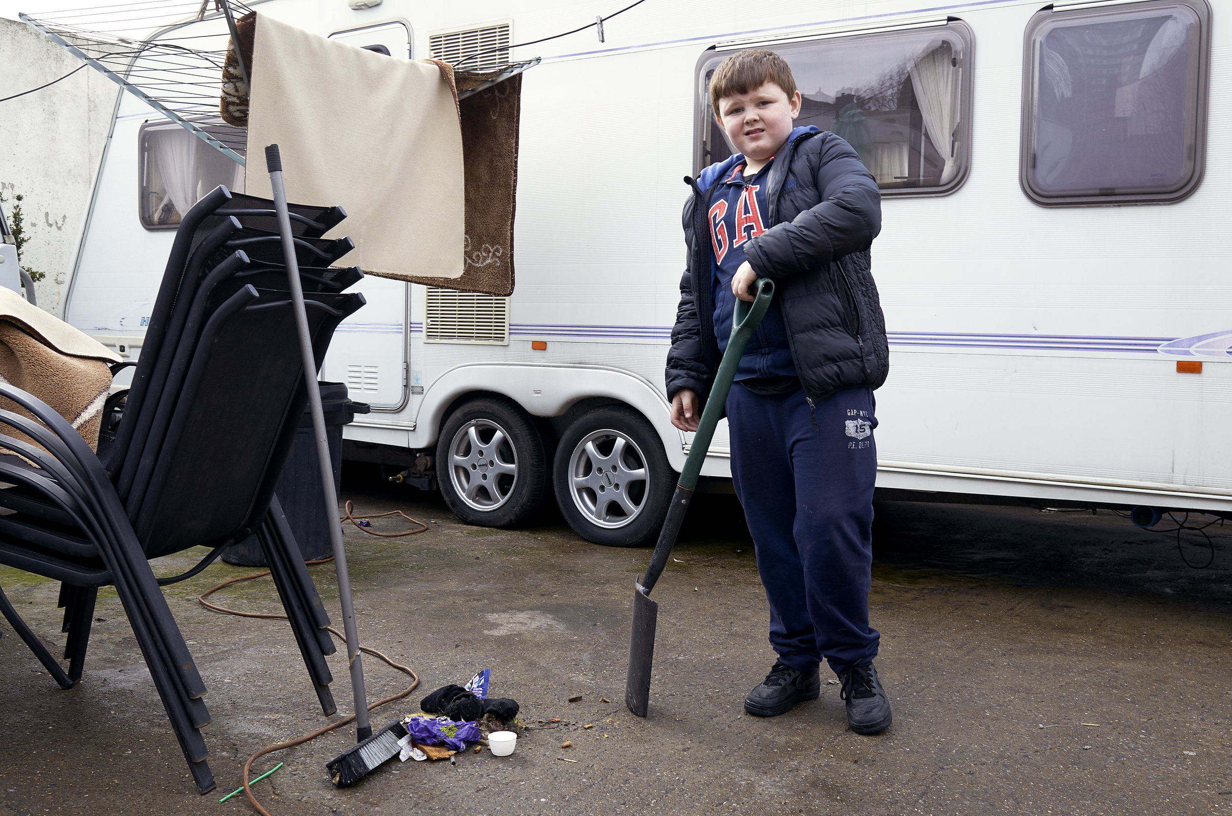  Taylor Ward pauses as he helps to tidy his family’s driveway.&nbsp; 