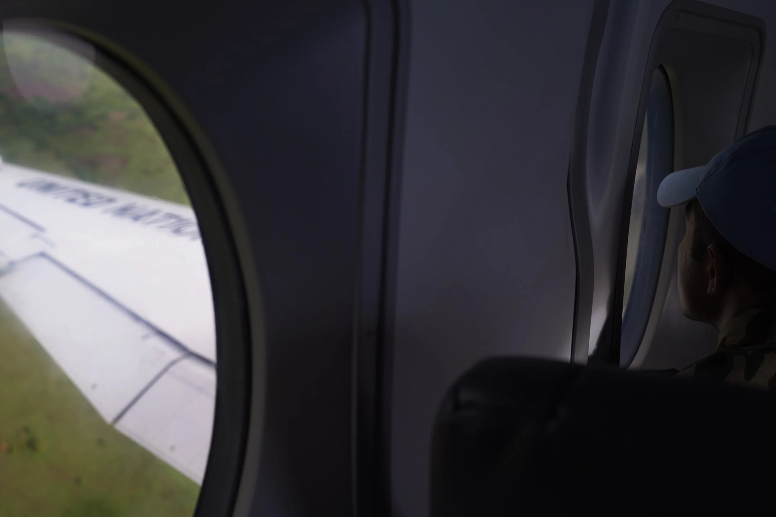 A MONUSCO soldier looks out of the passenger window of a United Nations flight coming into land in Beni, Ituri, Eastern DRC.