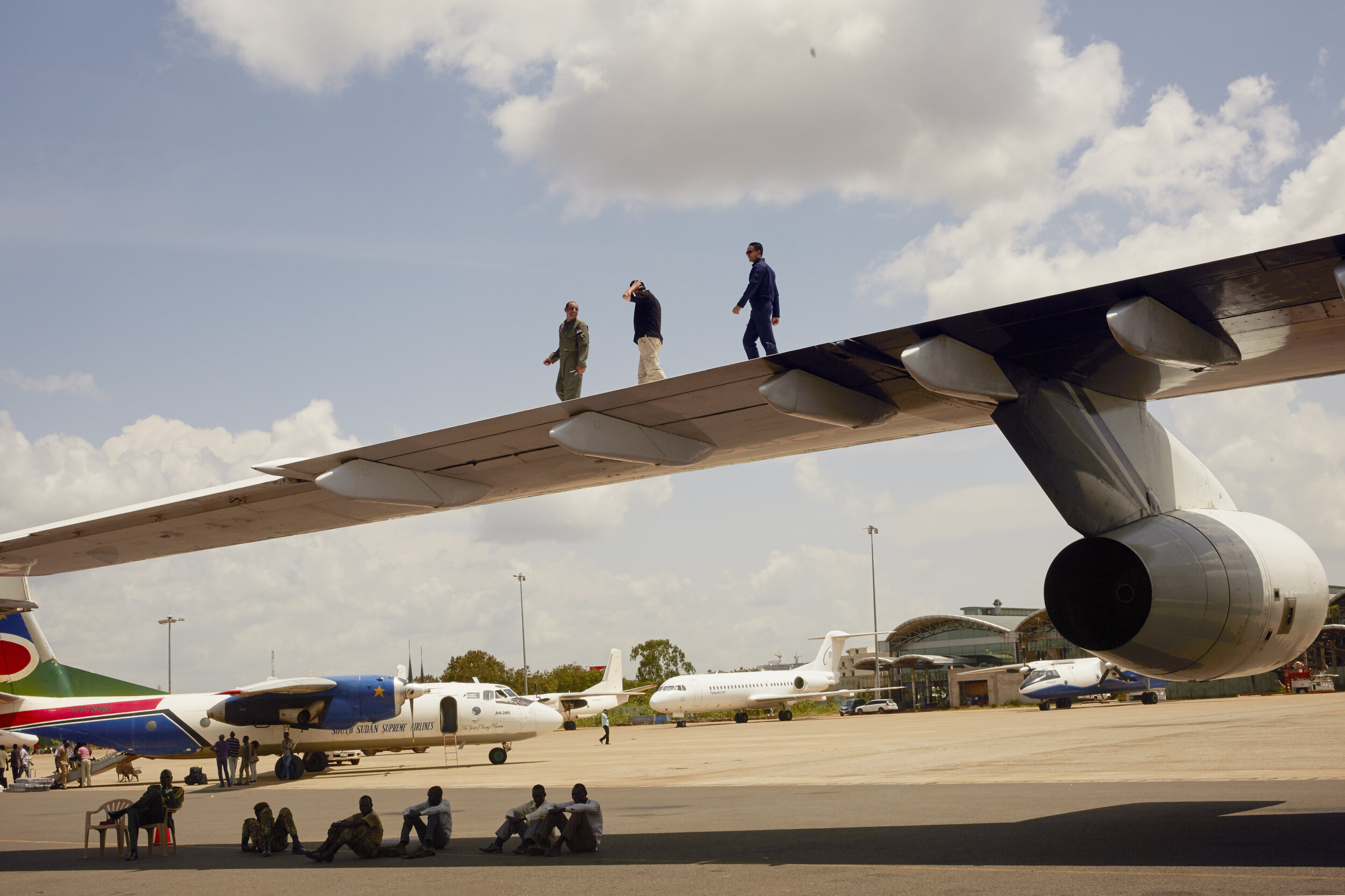 Egyptian Airforce pilots walk along the wing of an aircraft at Juba International Airport, South Sudan