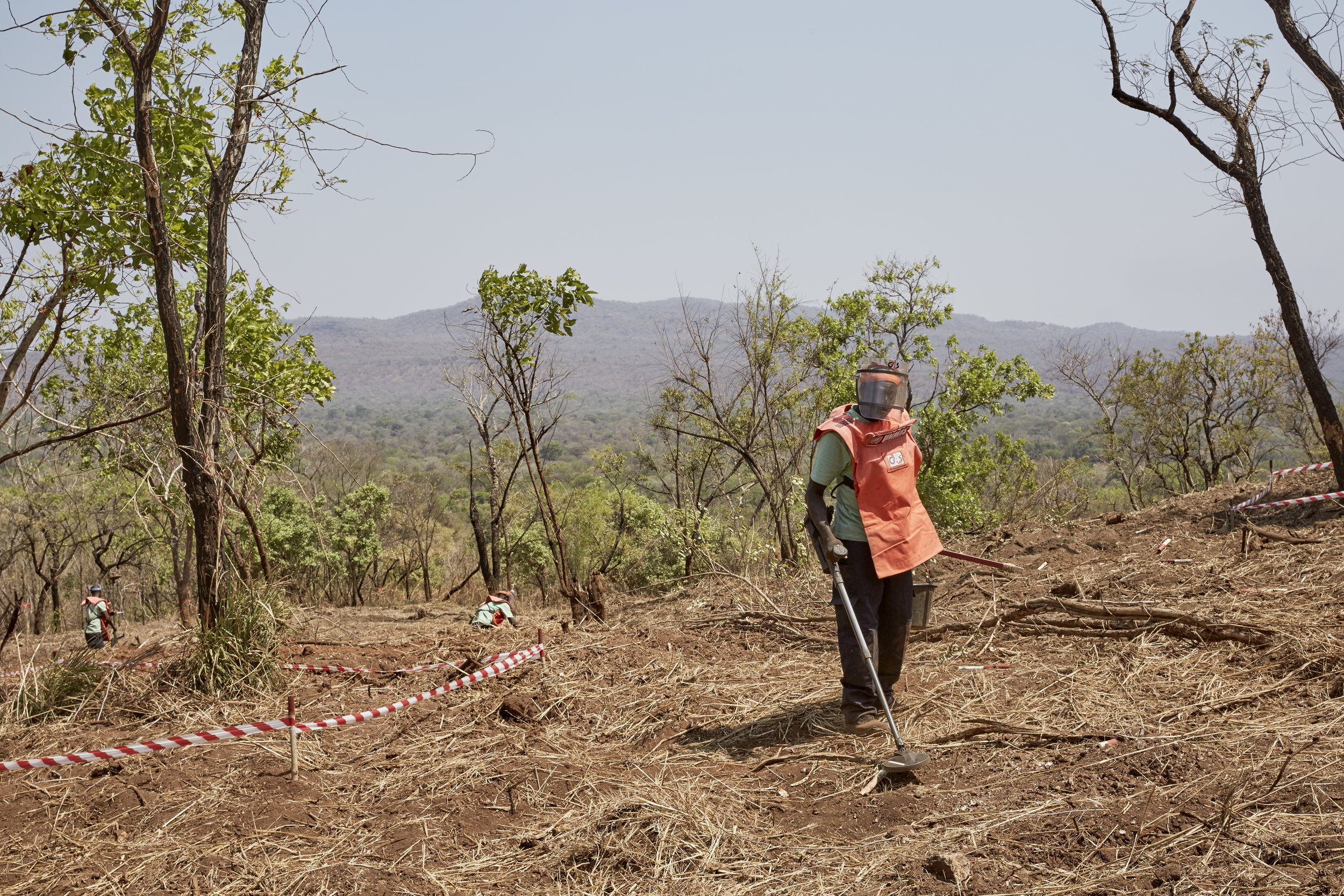 A man searches for unexploded ordinance on the road between Nimule and Juba, South Sudan