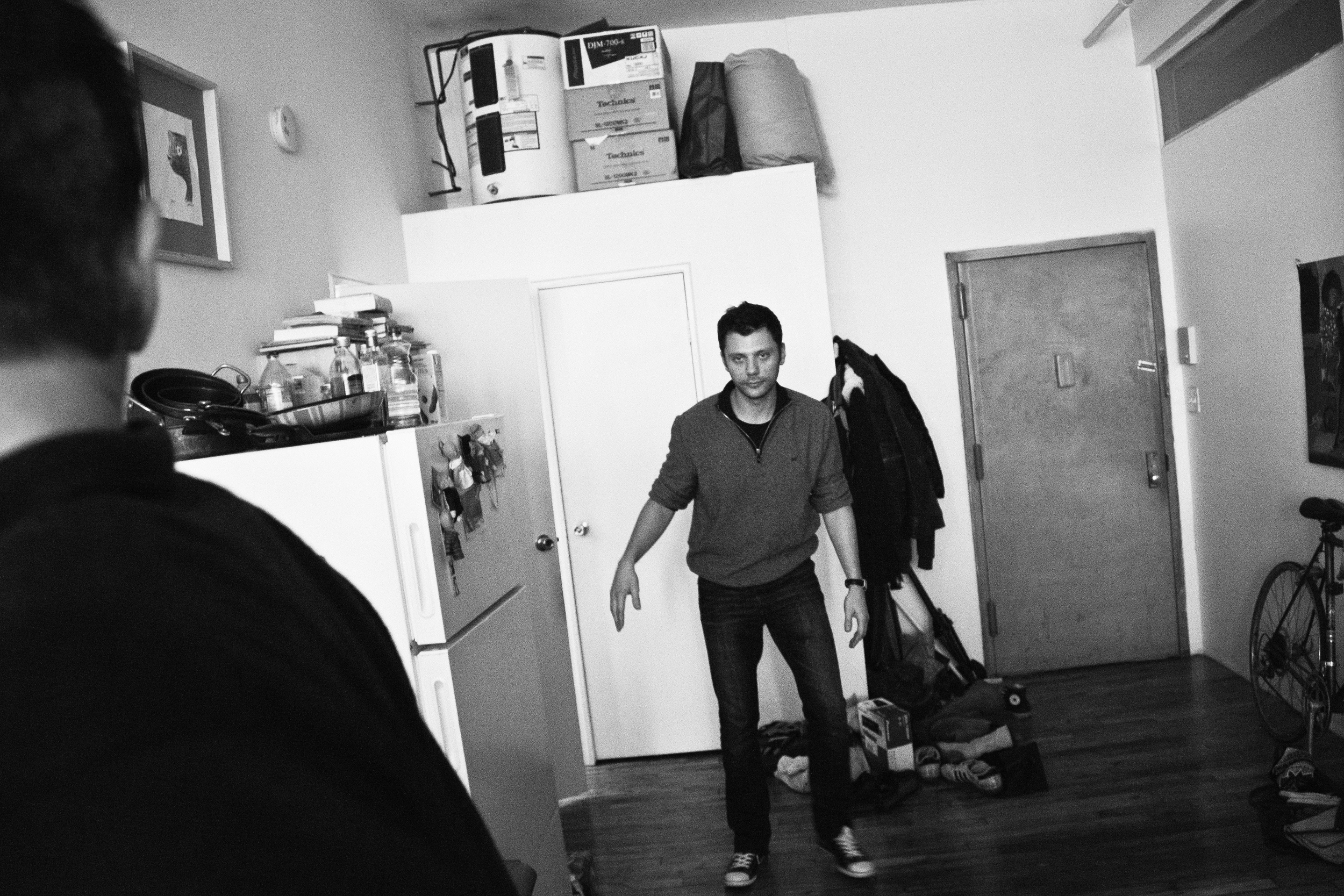 Droog member Andrei Osyka stumbles out of the restroom during a quiet afterparty in Brooklyn, NY.